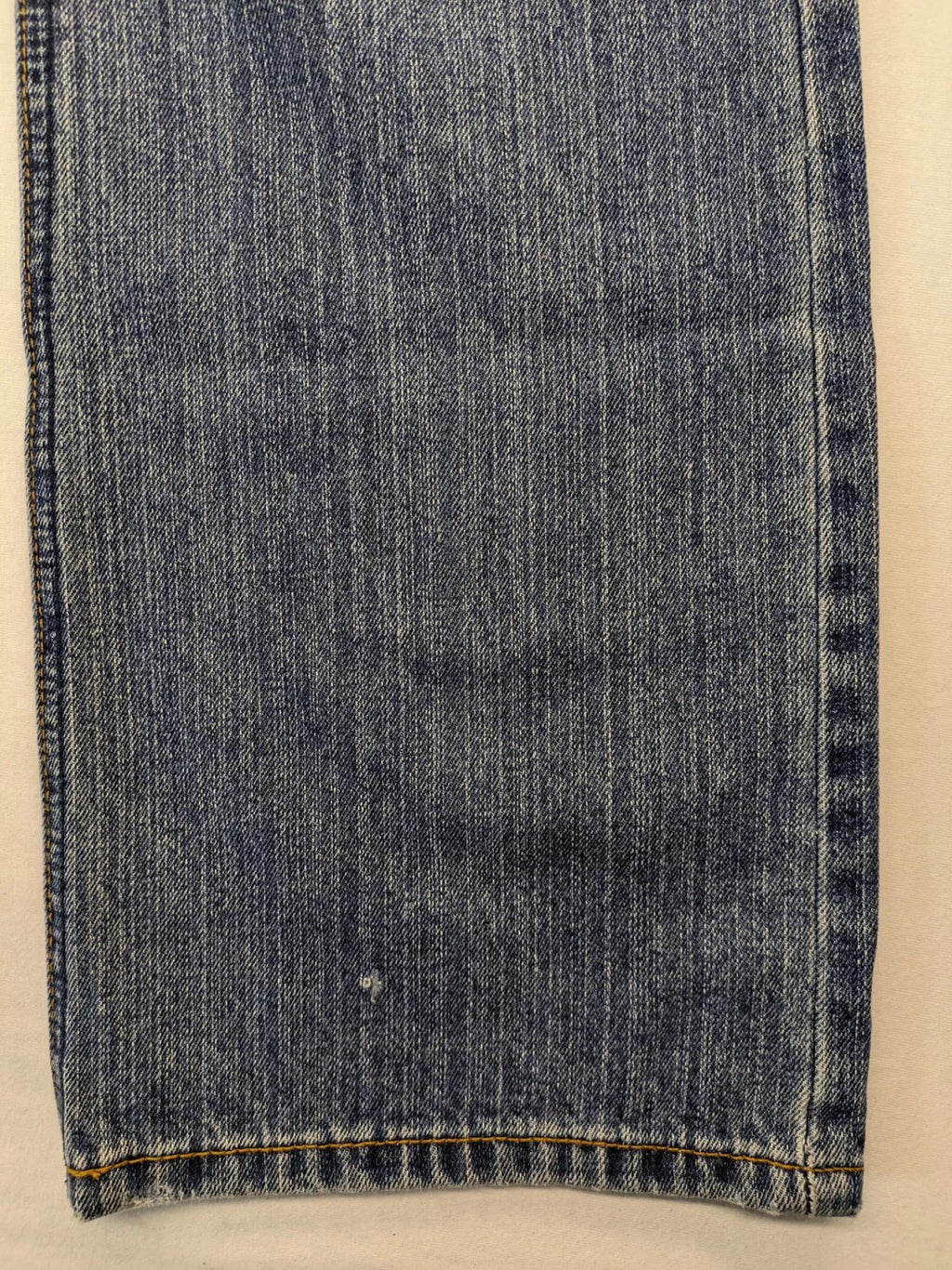 Zuni blue straight jeans 5-pocket design with zipper and decorative rivets.