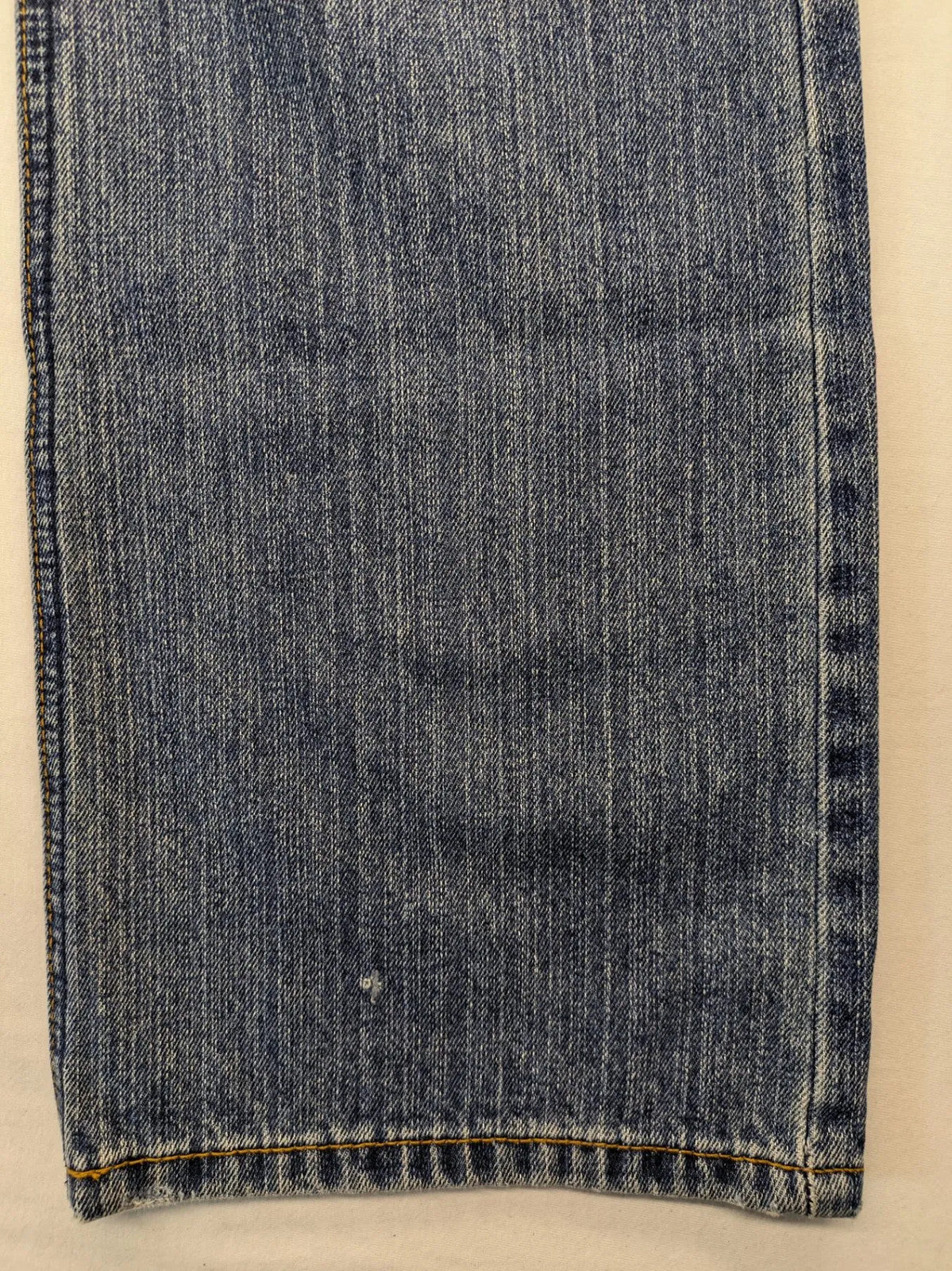 Zuni blue straight jeans 5-pocket design with zipper and decorative rivets.