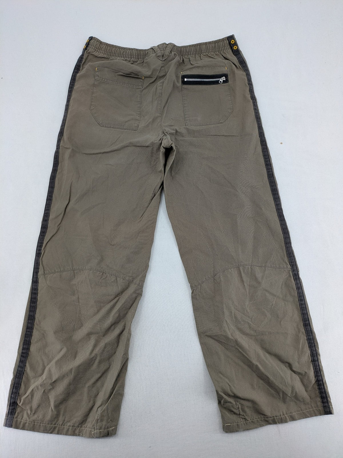 Nike khaki training pants with logo, elastic waistband, and practical pockets.