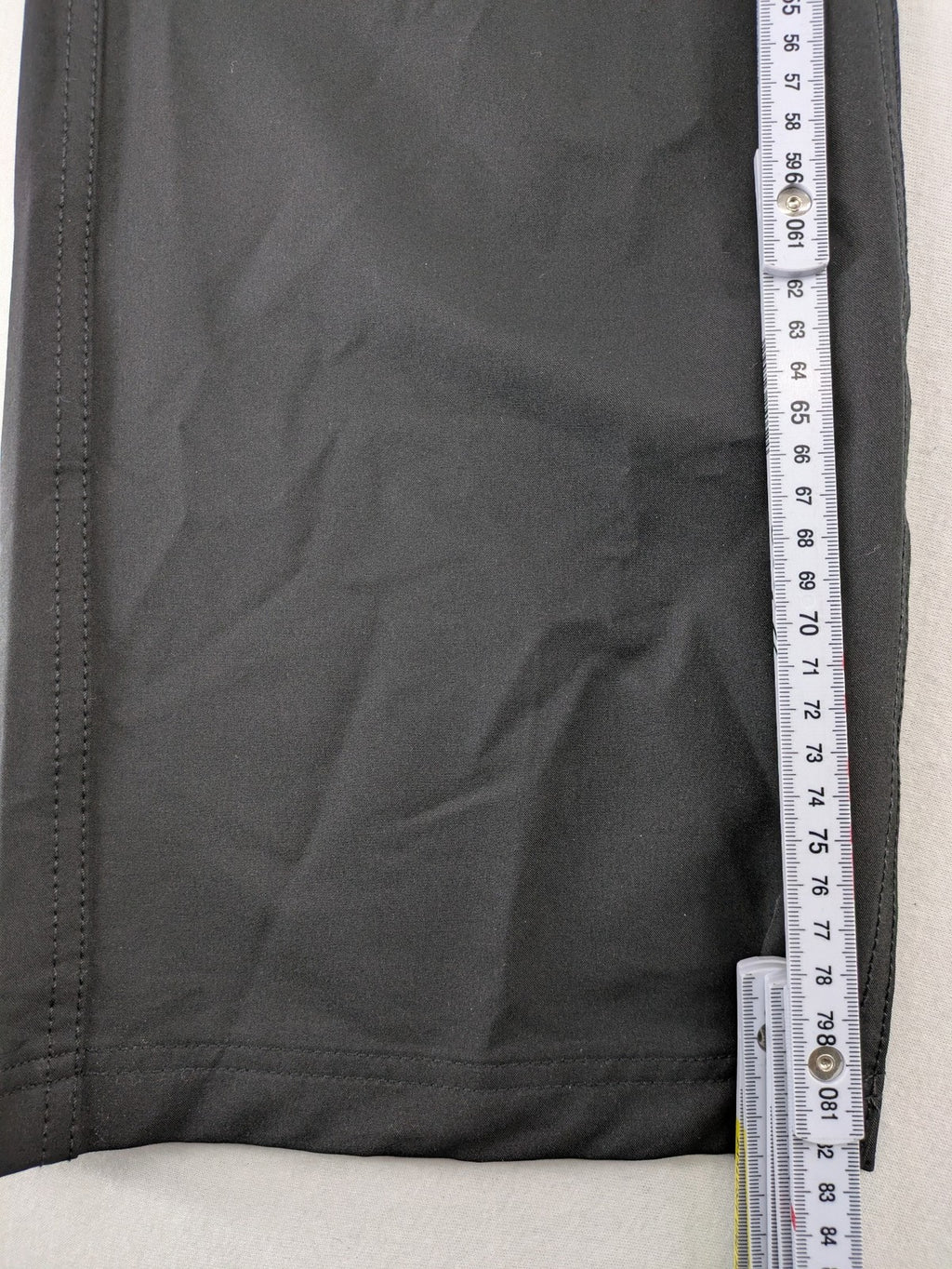 Outdoor grey trekking pants with zippered cargo pockets and durable stretch fabric.
