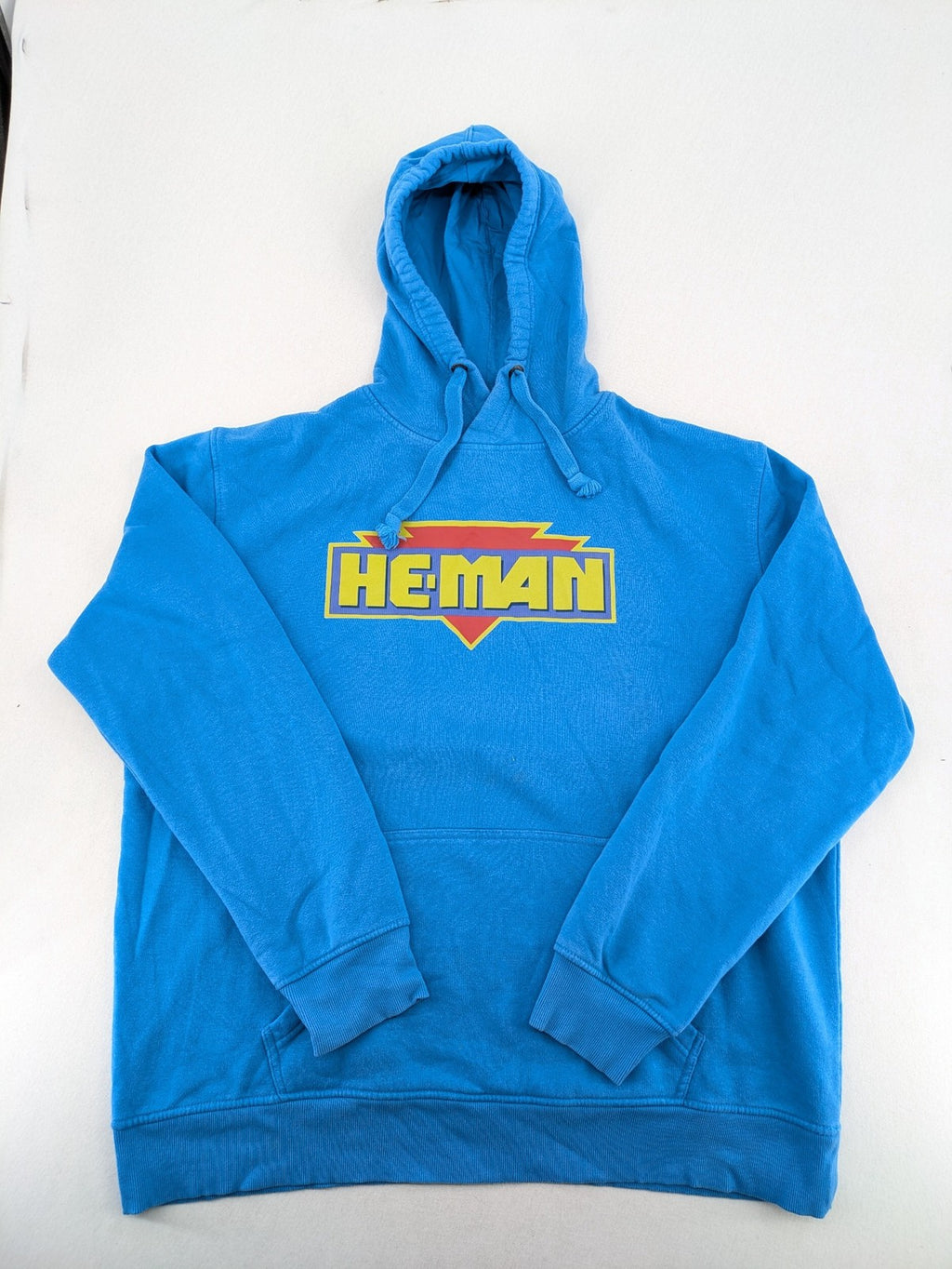 Masters of the Universe blue zip-through hoodie featuring large He-Man logo and drawstring hood.