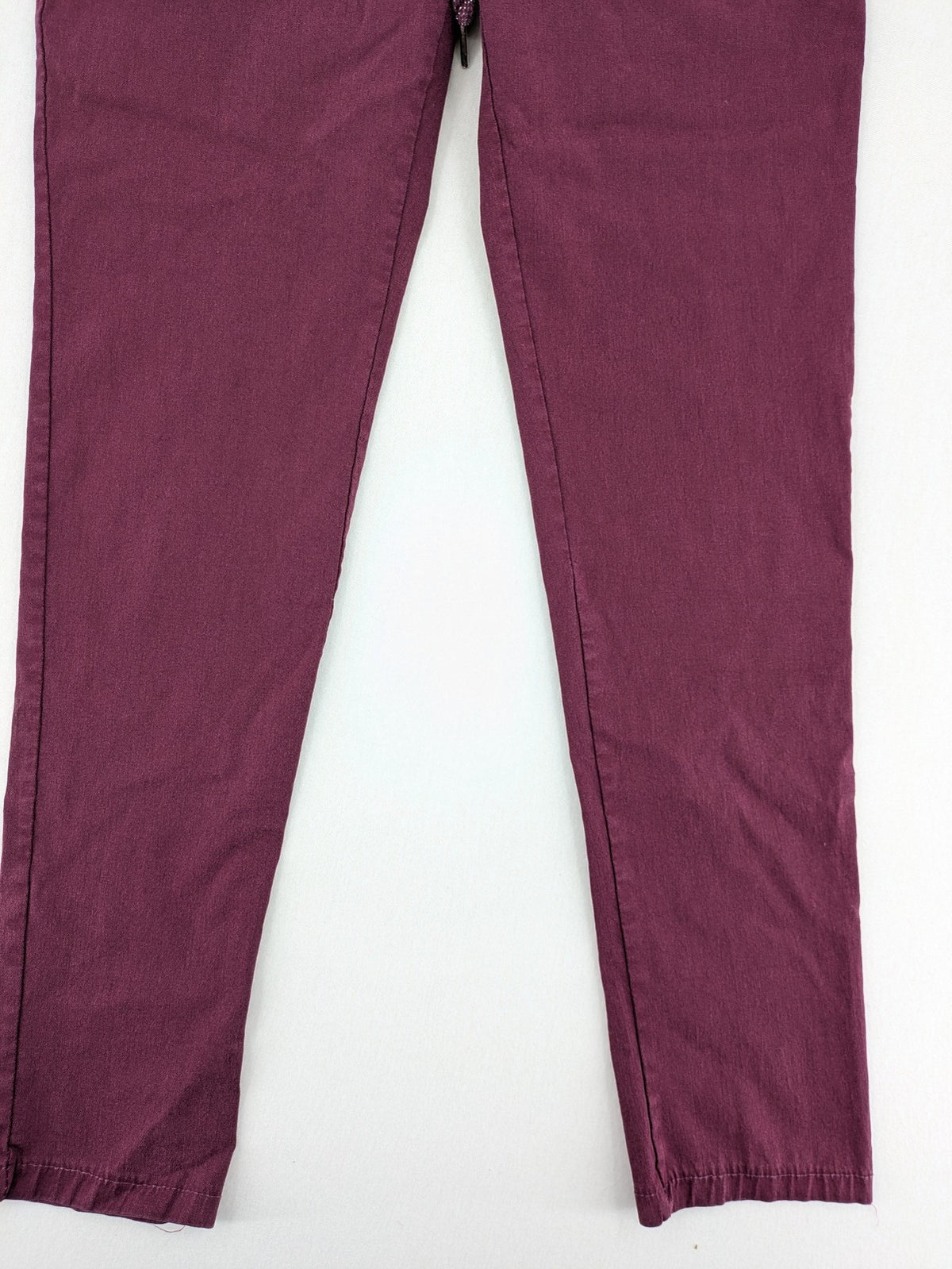 Pink Cherry pants pink stretchy fabric with decorative buttons and elastic waistband.