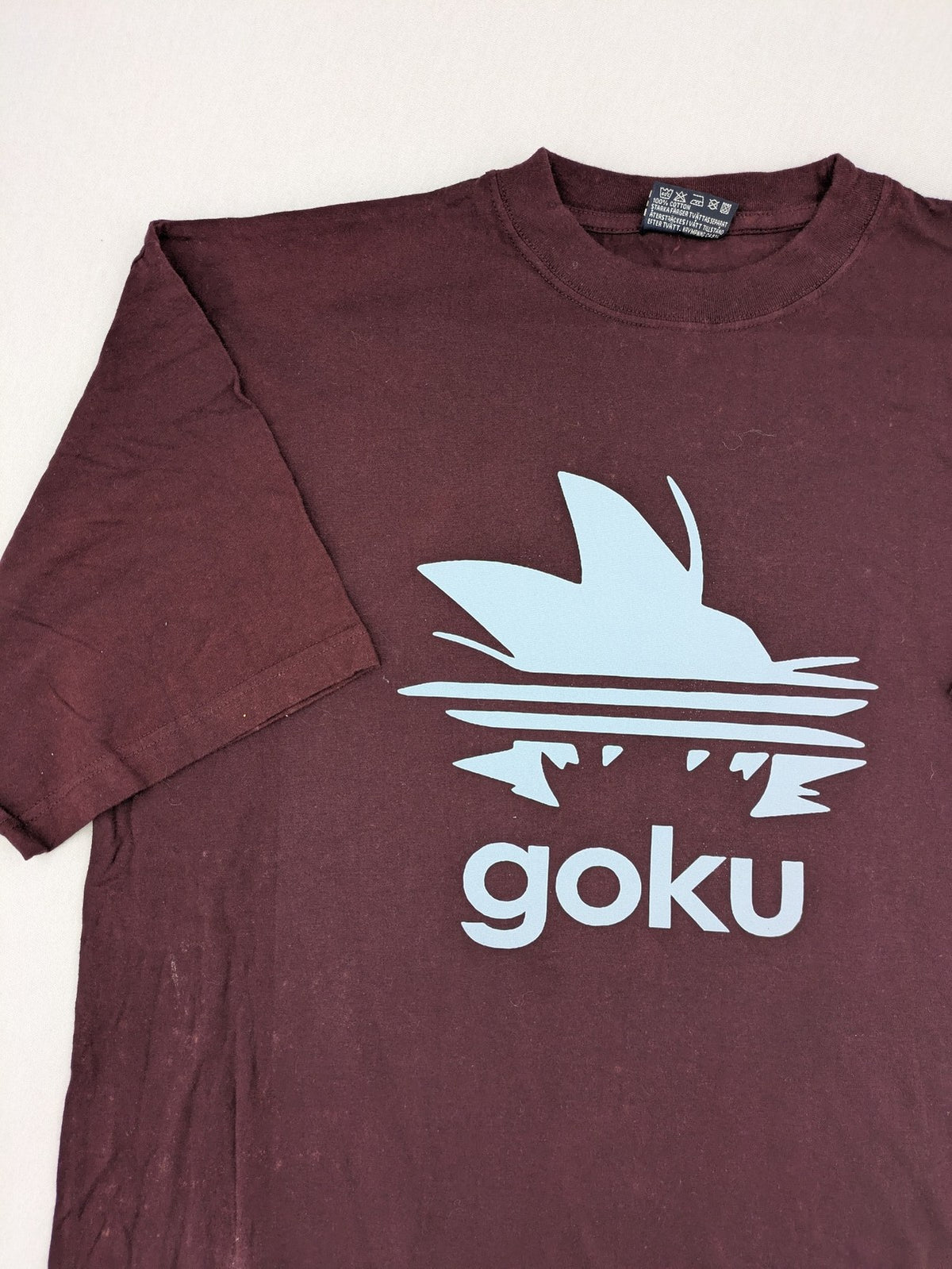 ADI band t-shirt burgundy with blue graphic parody of Adidas logo and Goku silhouette