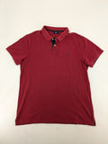 GANT burgundy polo shirt with embroidered shield logo and contrasting navy collar details.