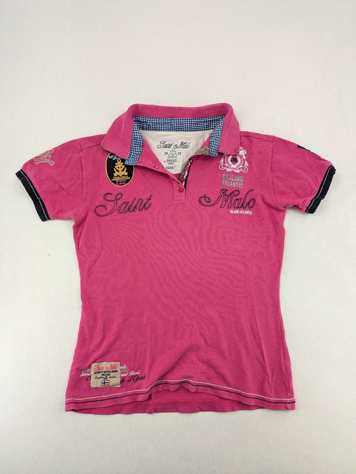 Geographical Norway pink polo shirt with embroidered Saint Malo design and Gingham trim.