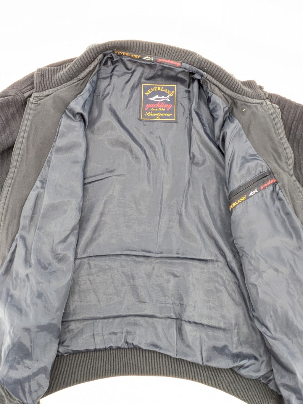 Neverland grey and navy full zip turtle neck jumper with ribbed knit and shoulder patches.