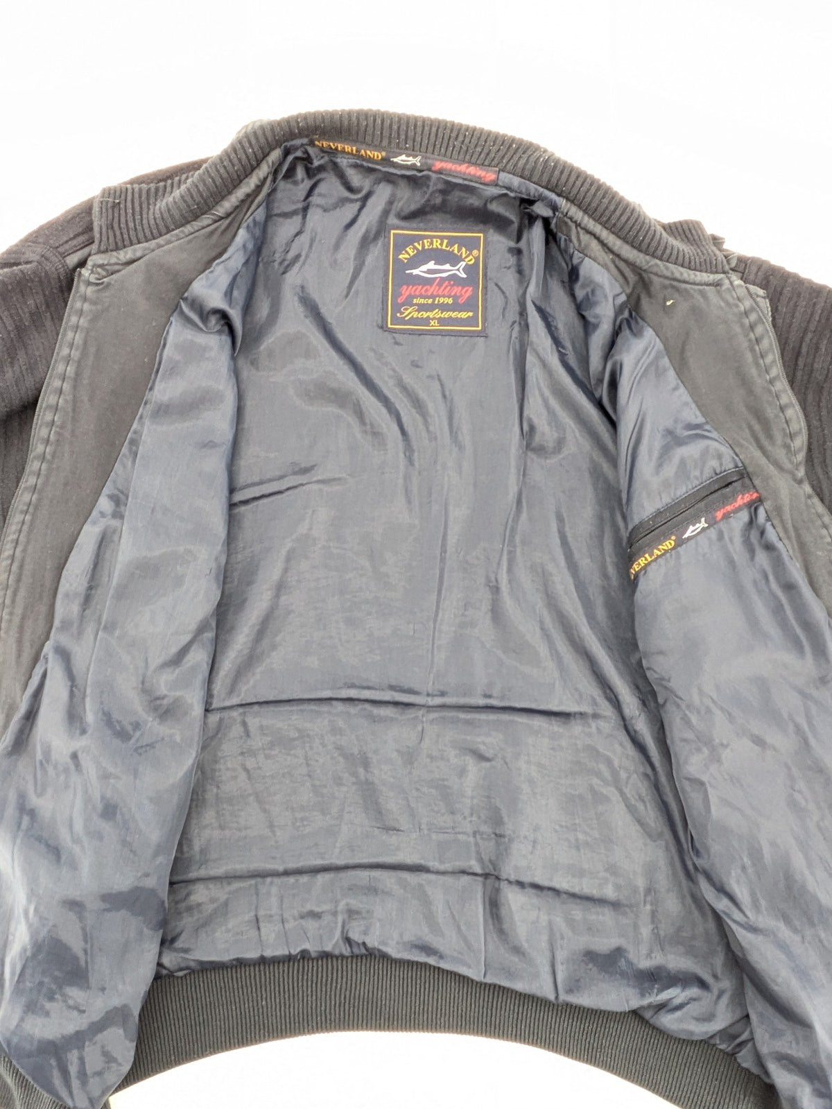 Neverland grey and navy full zip turtle neck jumper with ribbed knit and shoulder patches.