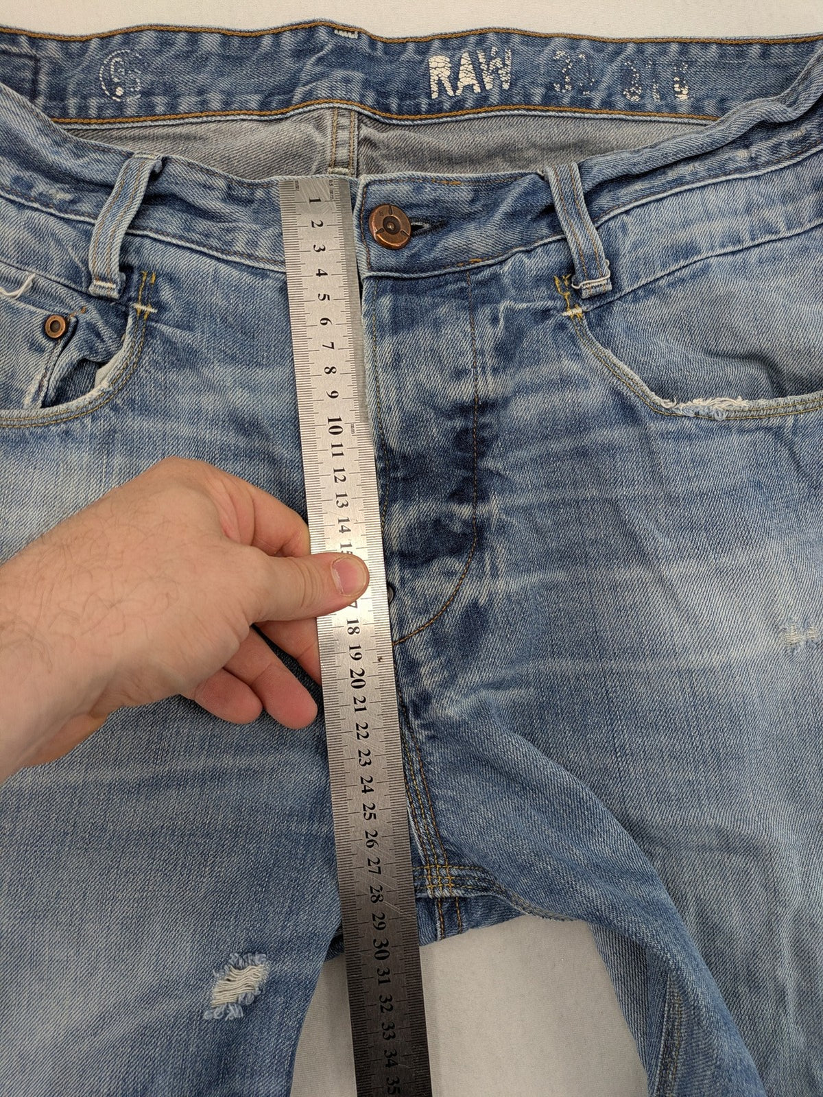 G-Star Raw blue straight jeans with distressed details and classic button fly.
