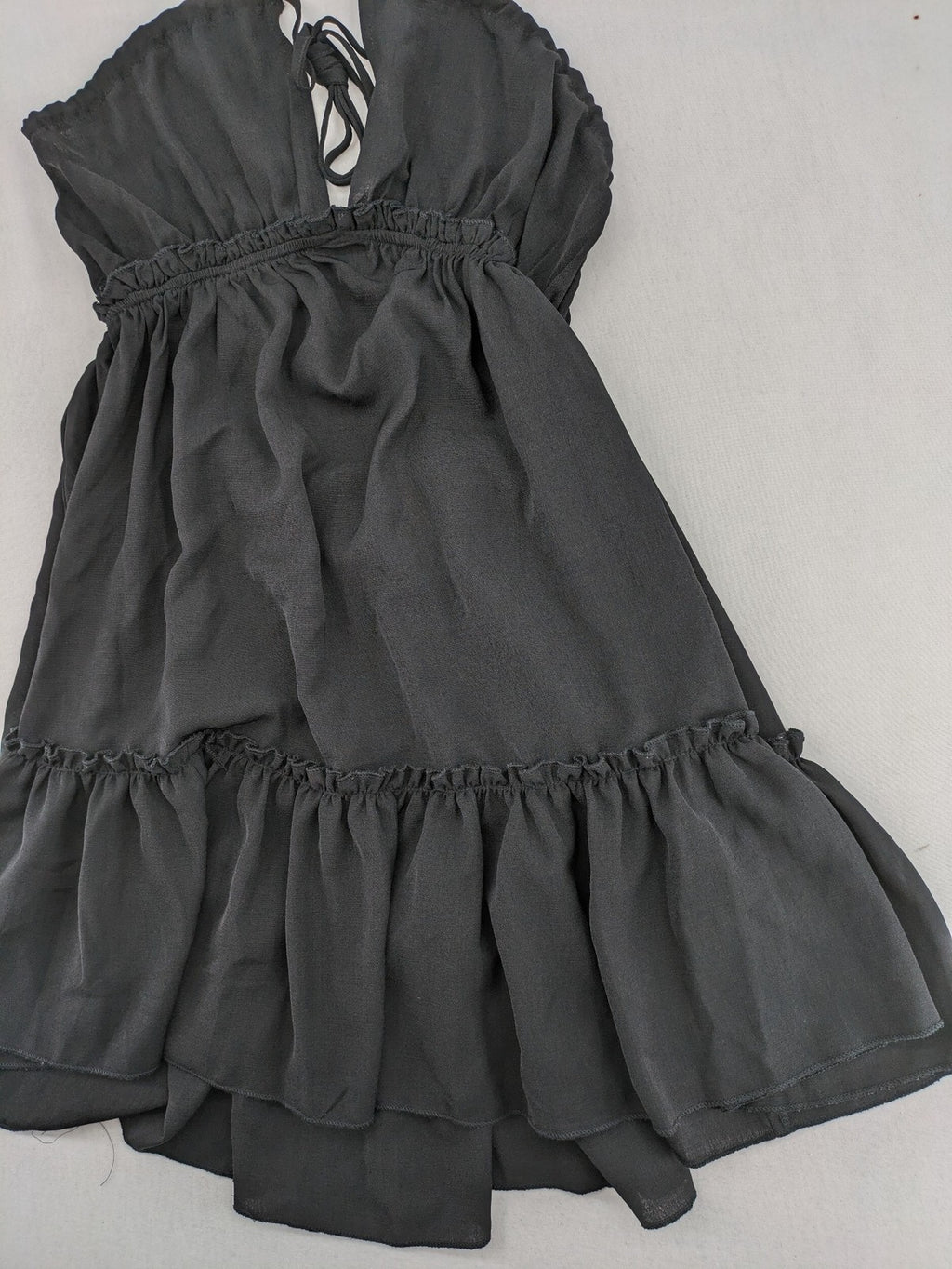 SHEIN grey mini dress with open back, adjustable tie, and ruffled hem.