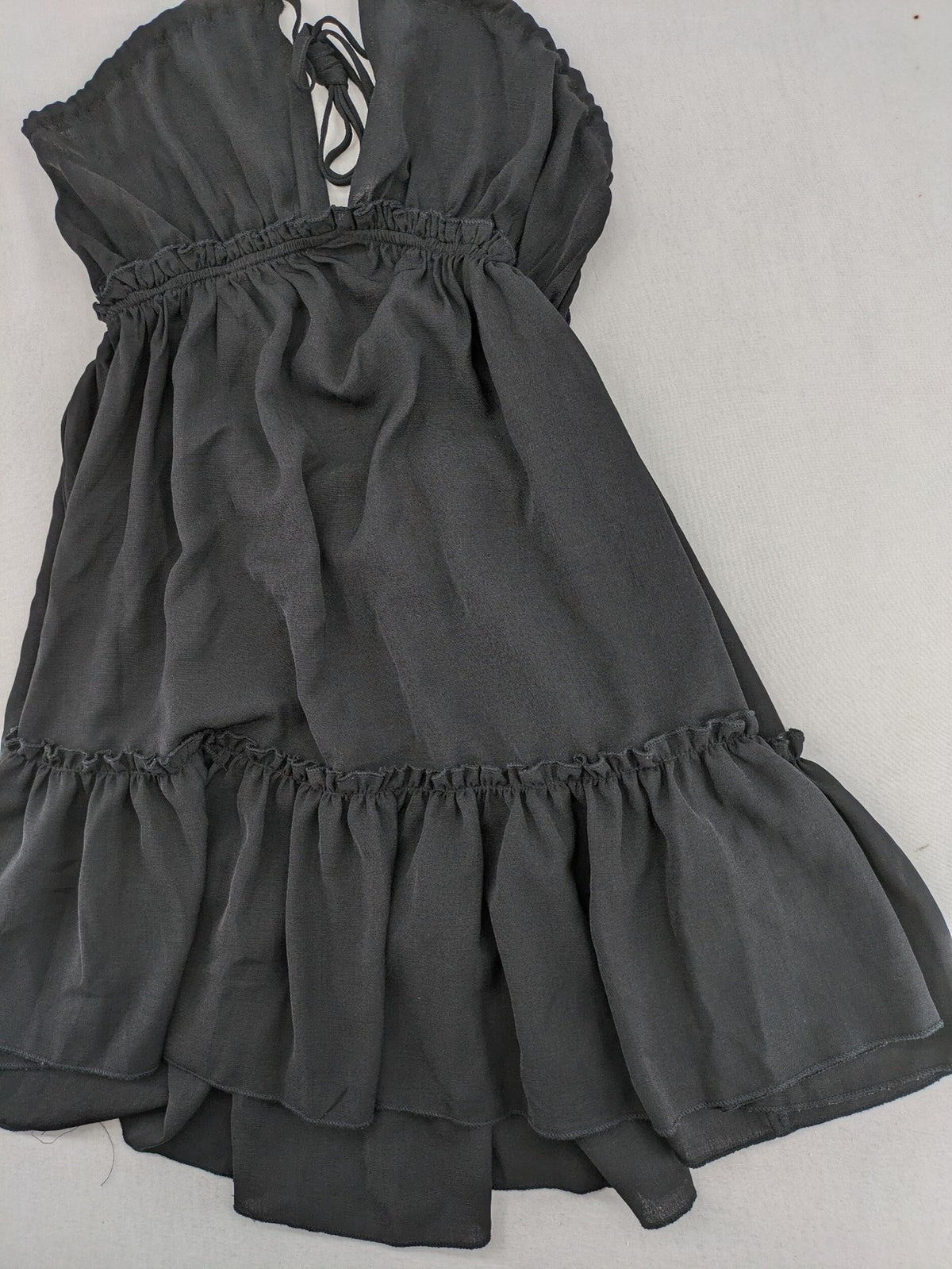 SHEIN grey mini dress with open back, adjustable tie, and ruffled hem.