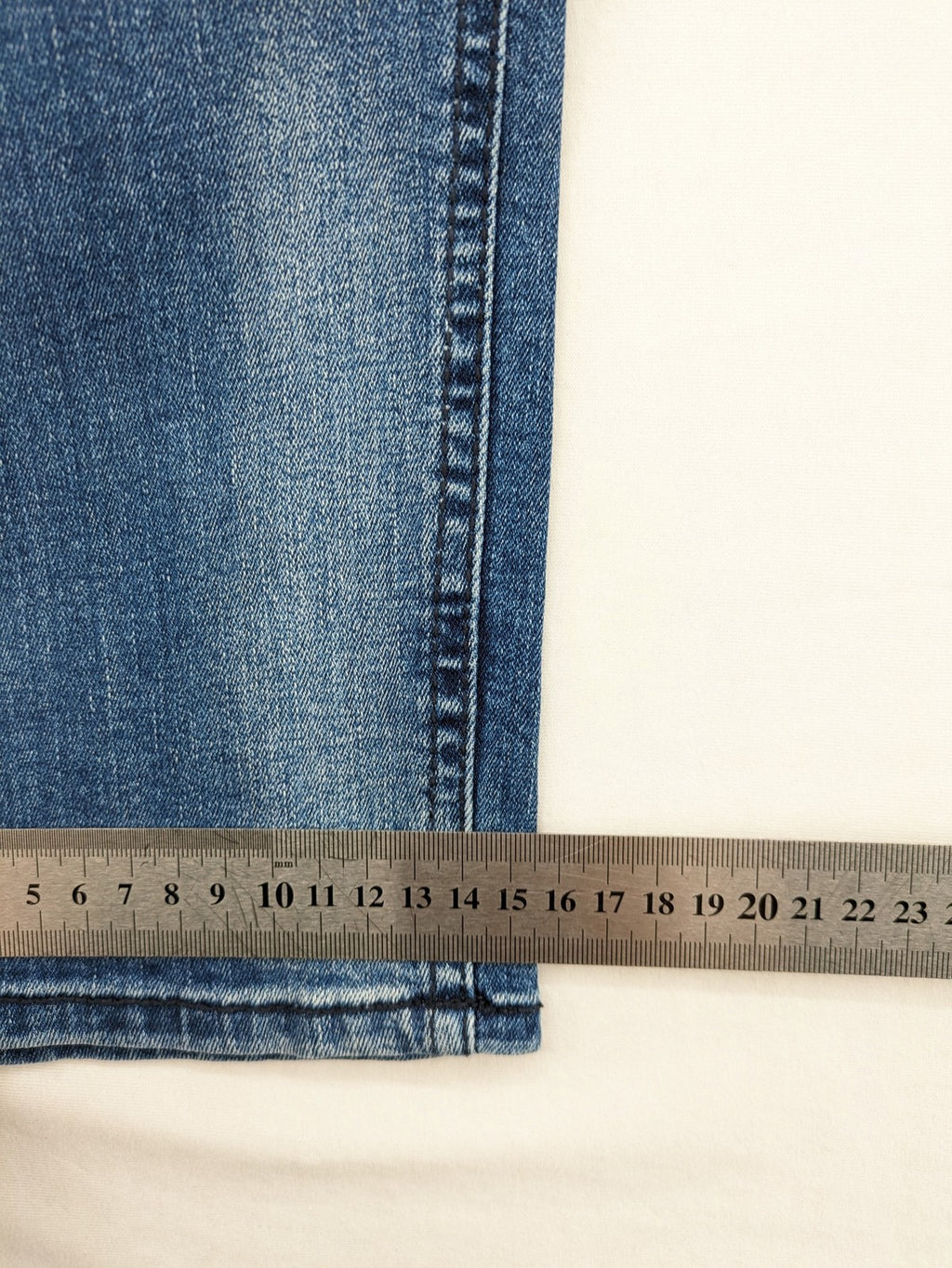 Crosshatch blue slim fit jeans with faded wash and logo patch on back pocket.