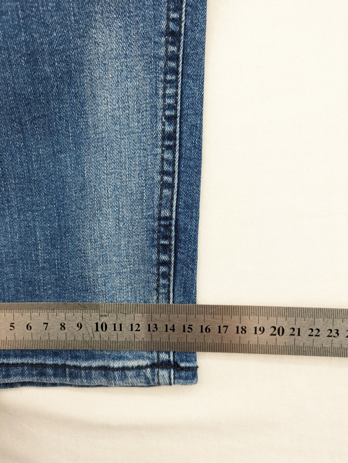 Crosshatch blue slim fit jeans with faded wash and logo patch on back pocket.