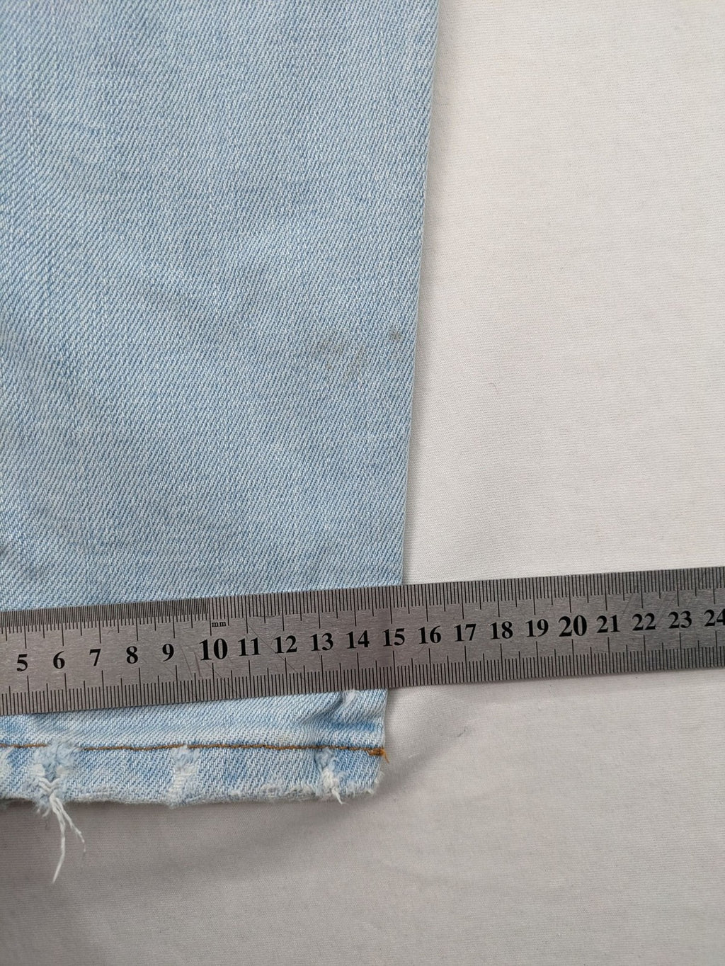 Zara blue straight jeans with distressed knees and classic button fly.
