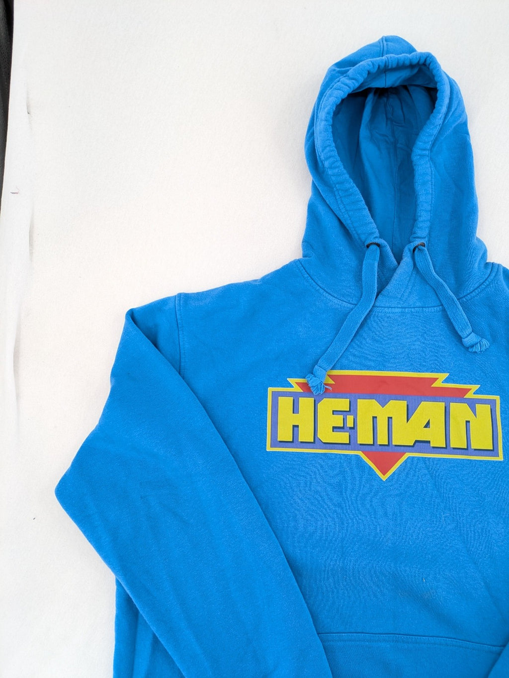 Masters of the Universe blue zip-through hoodie featuring large He-Man logo and drawstring hood.