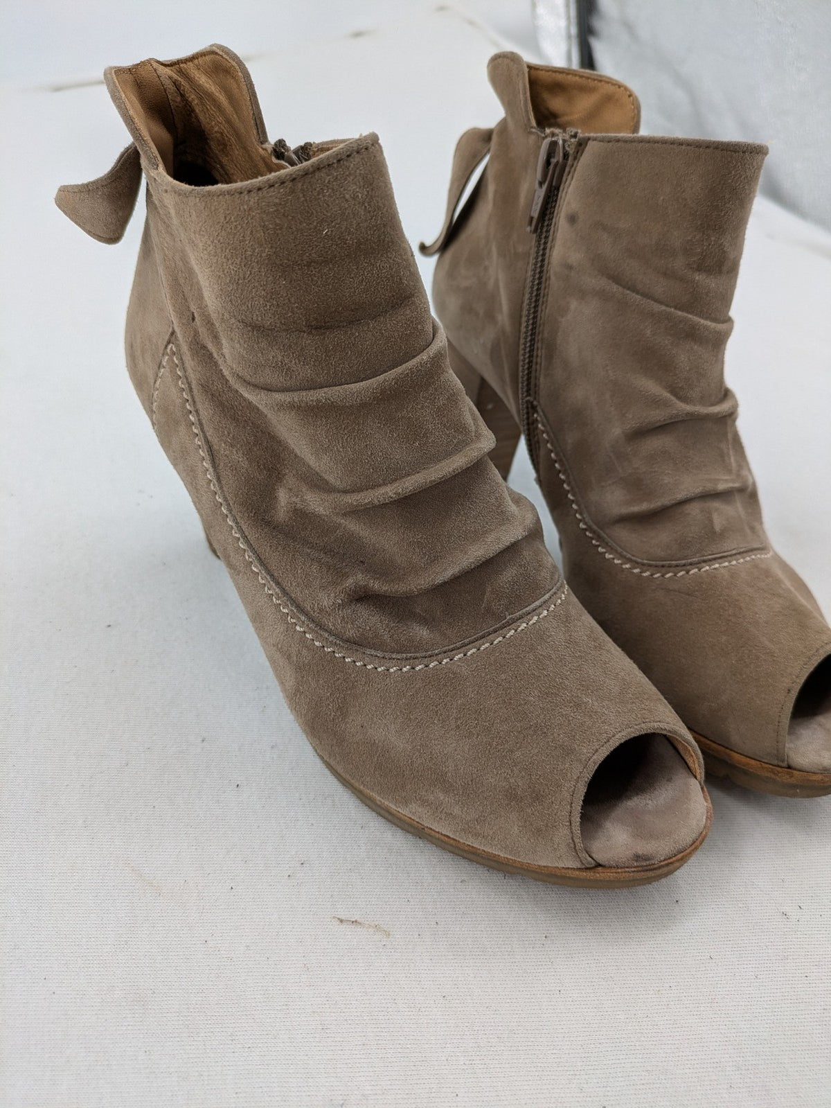 Paul Green taupe suede ankle boots with gathered front, peep toe, and block heel.