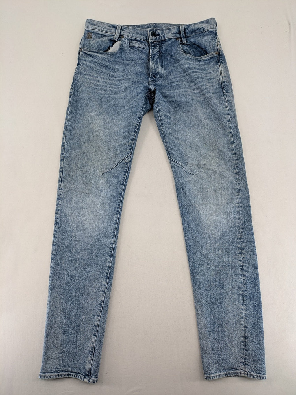 G-Star Raw blue slim fit jeans with 5-pocket design and light wash denim.