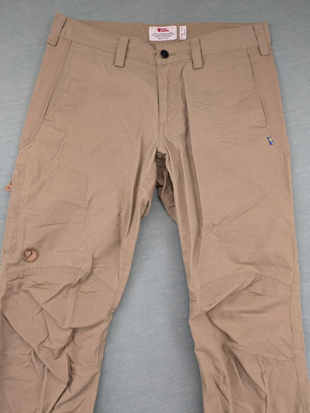 Fjällräven beige pants regular fit durable fabric outdoor style with logo detail.