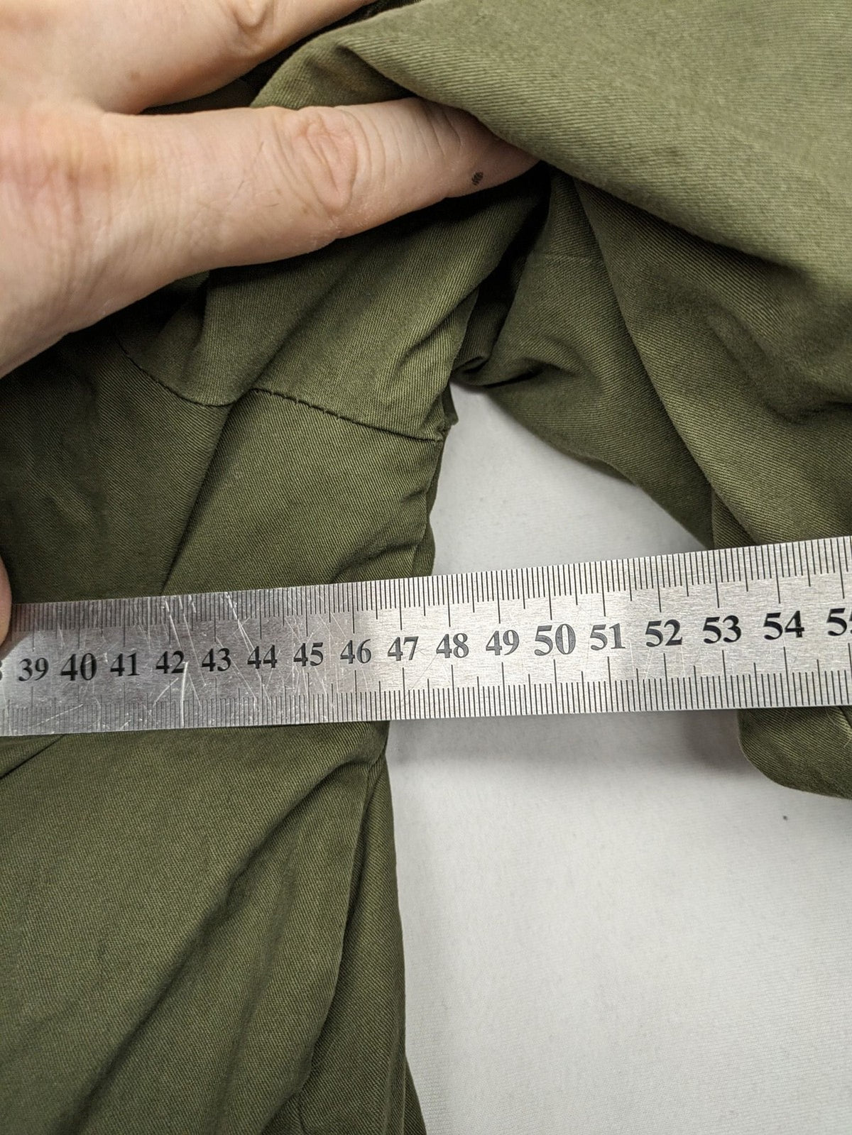 Vp Fashion khaki parka coat with "Bloomin' Lovely" floral embroidery and quilted lining.