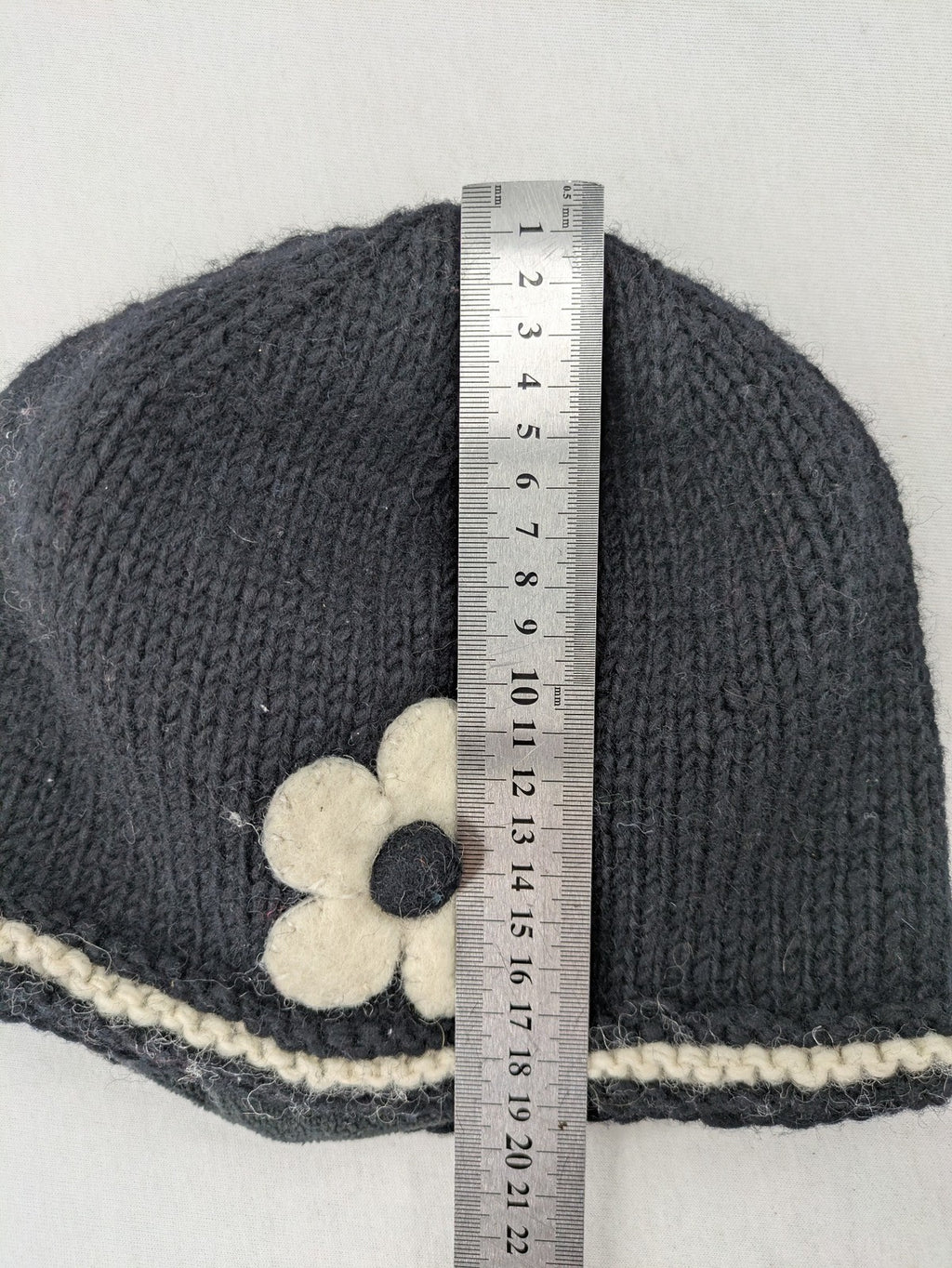 Fischers Textil multi beanie hand-knitted wool with fleece lining and floral appliqué.