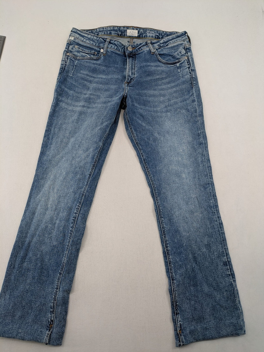 QS by s.Oliver green bootcut jeans with ankle zippers and classic denim wash.