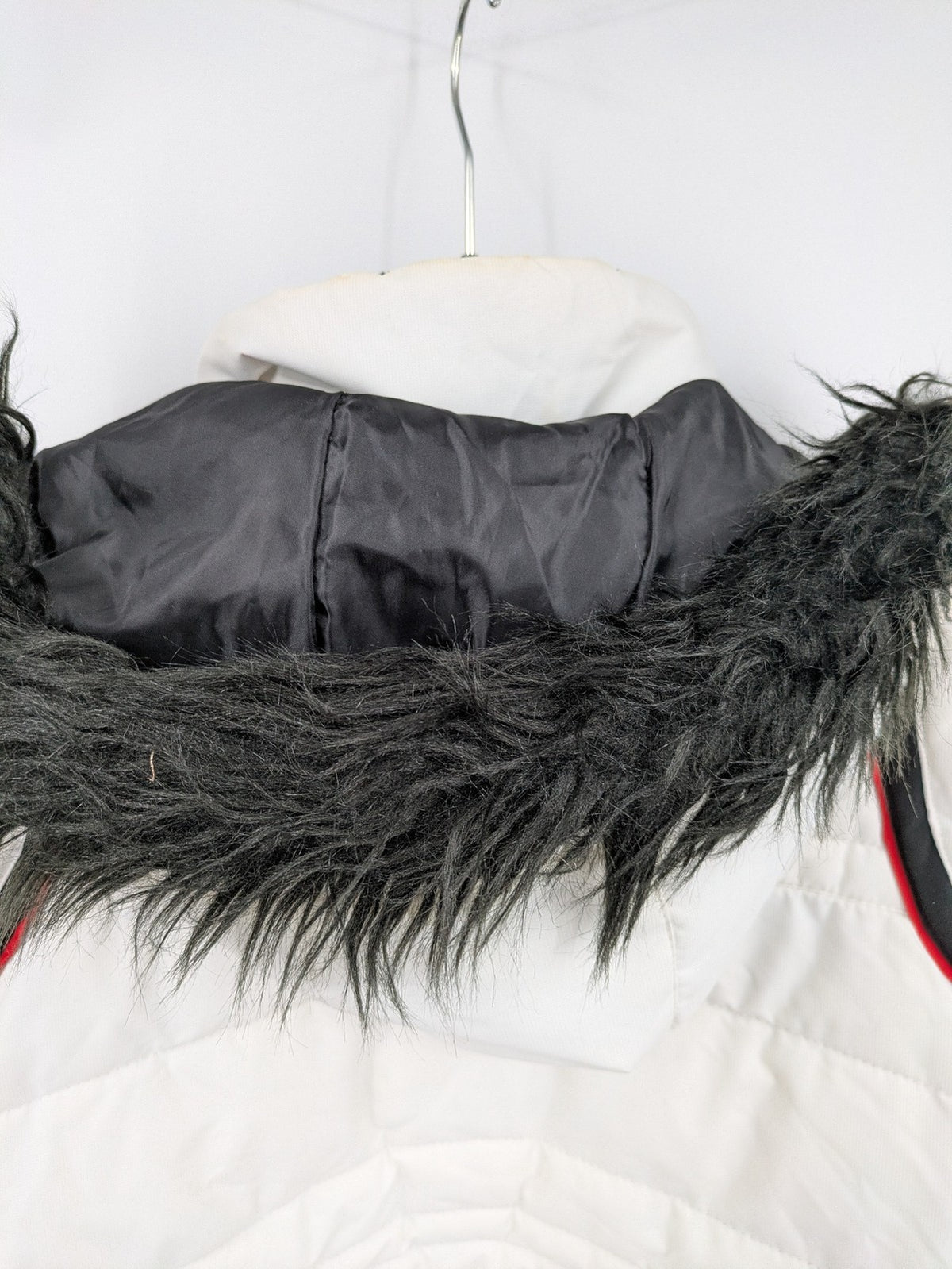 Janina white puffer jacket with quilted design and faux fur hood accents.