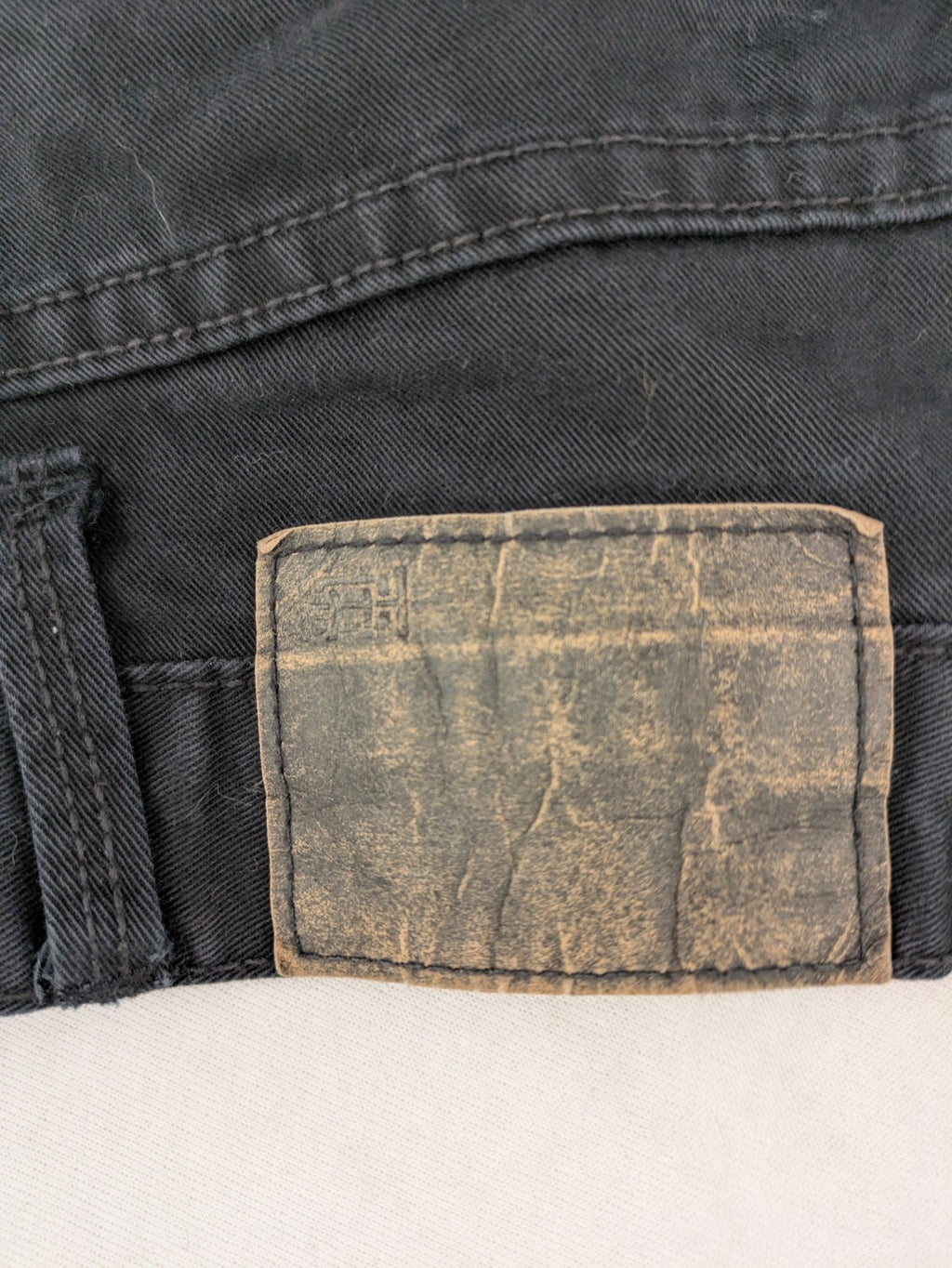 Ckh grey straight fit jeans with button fly and faded wash details.