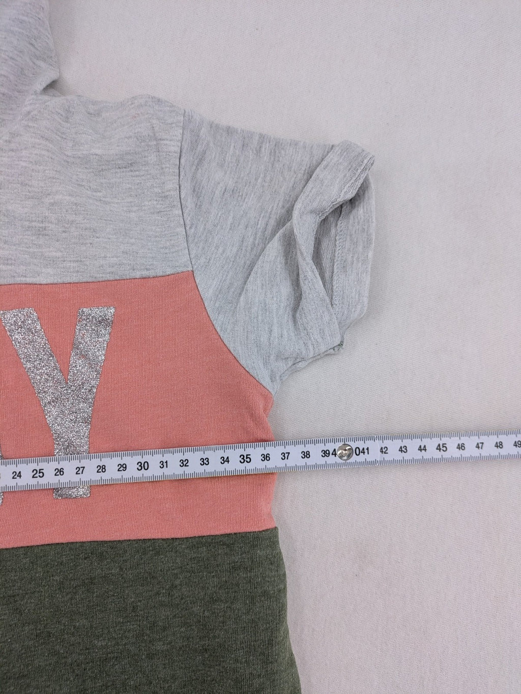 DKNY pink hoodie dress colorblock design with glitter logo and short sleeves.