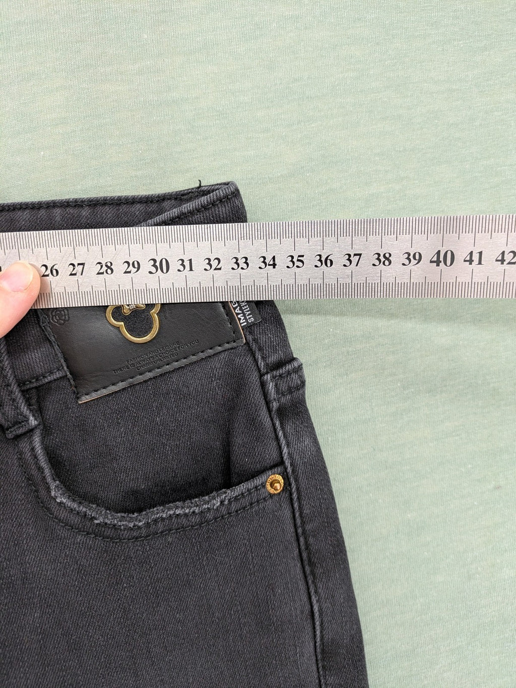 Disney black straight jeans with Minnie Mouse detail, cropped length, stretchy cotton blend.