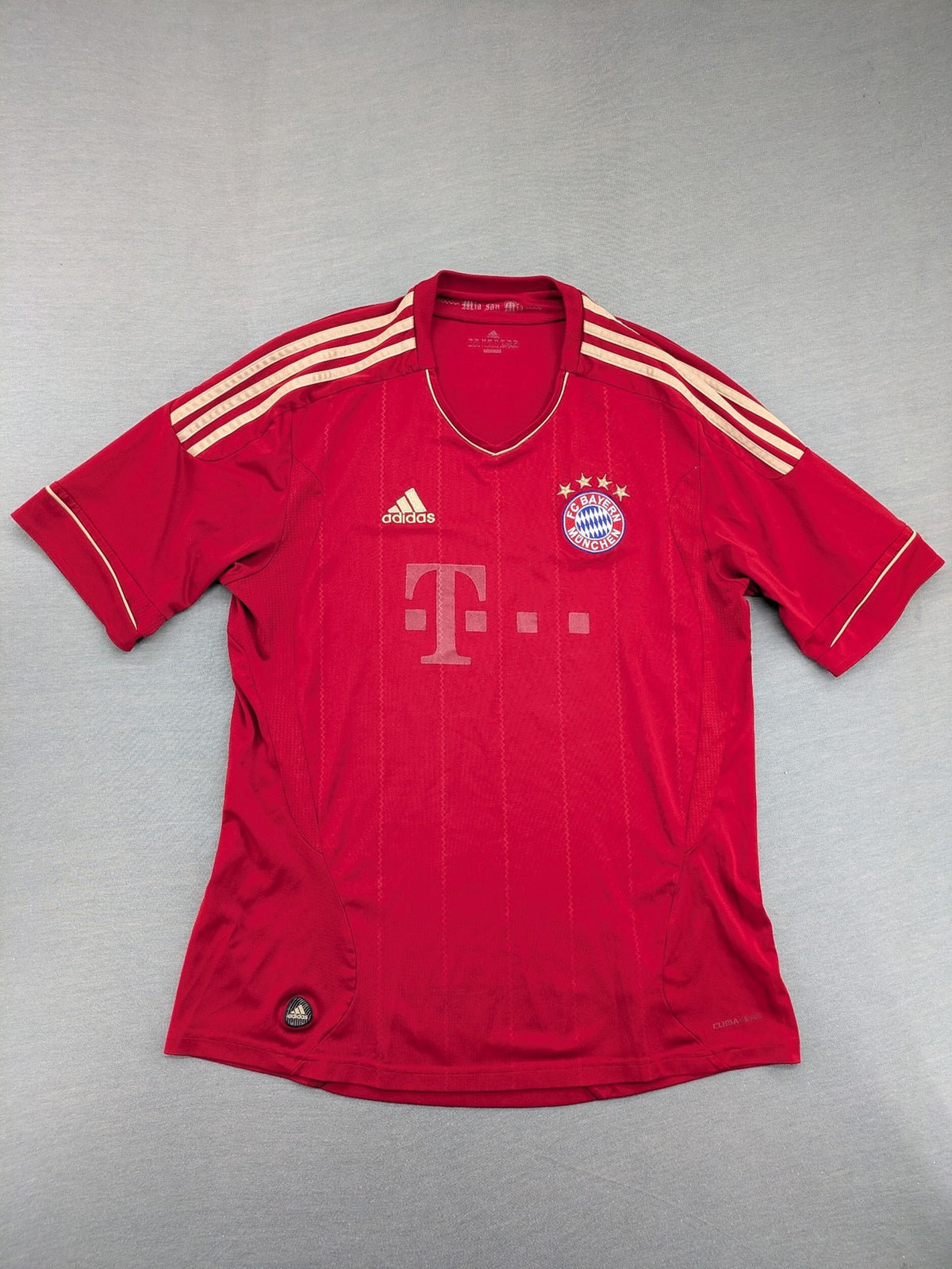 Adidas red soccer uniform with embroidered FC Bayern München crest and T-Mobile logo.
