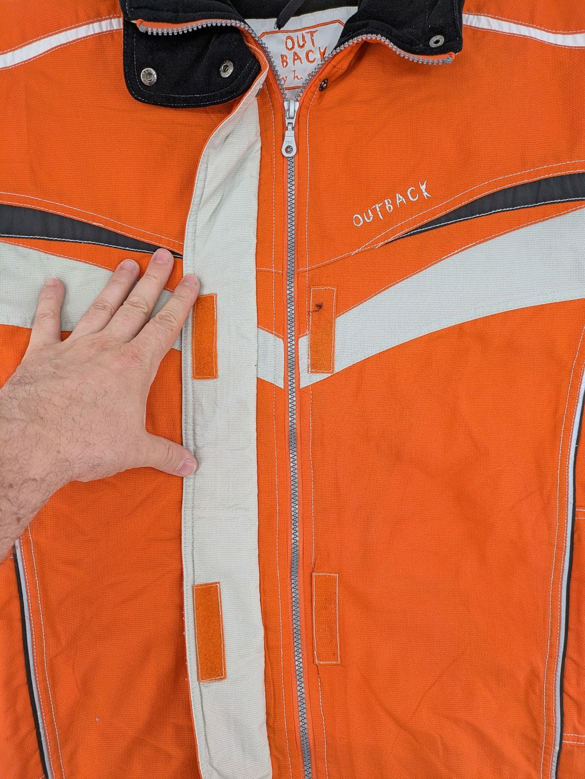 Outback orange outdoor jacket size 42 with reflective accents and mixed color details.