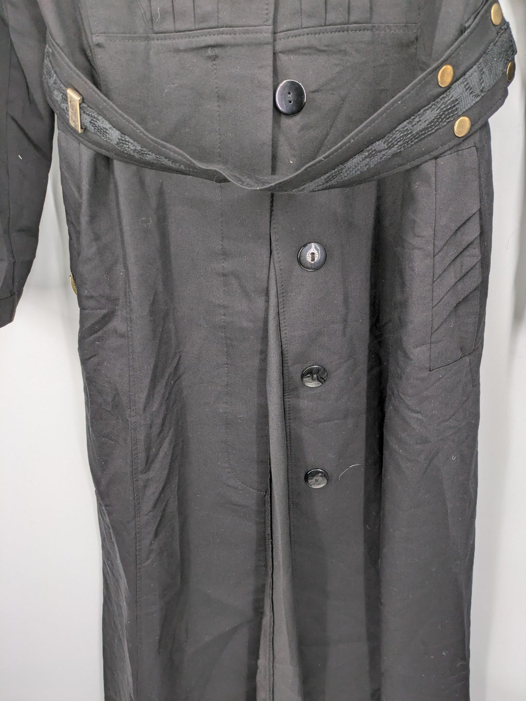 Alvina black trench coat with lace collar and gold buttons, belted waist design.