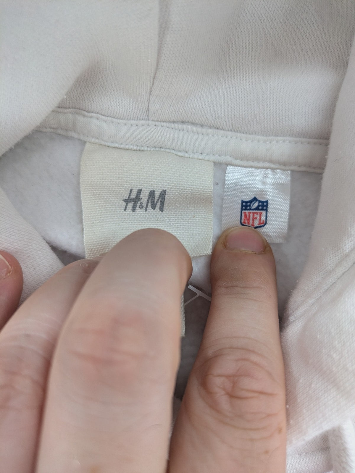 New York white hoodie with raised blue and red "GIANTS" logo and adjustable hood.