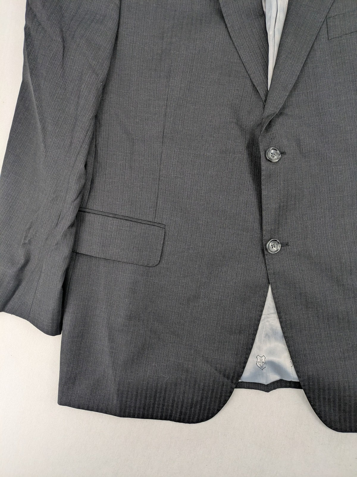 Desch grey blazer with dark grey pinstripe pattern, satin lining, and tailored design.