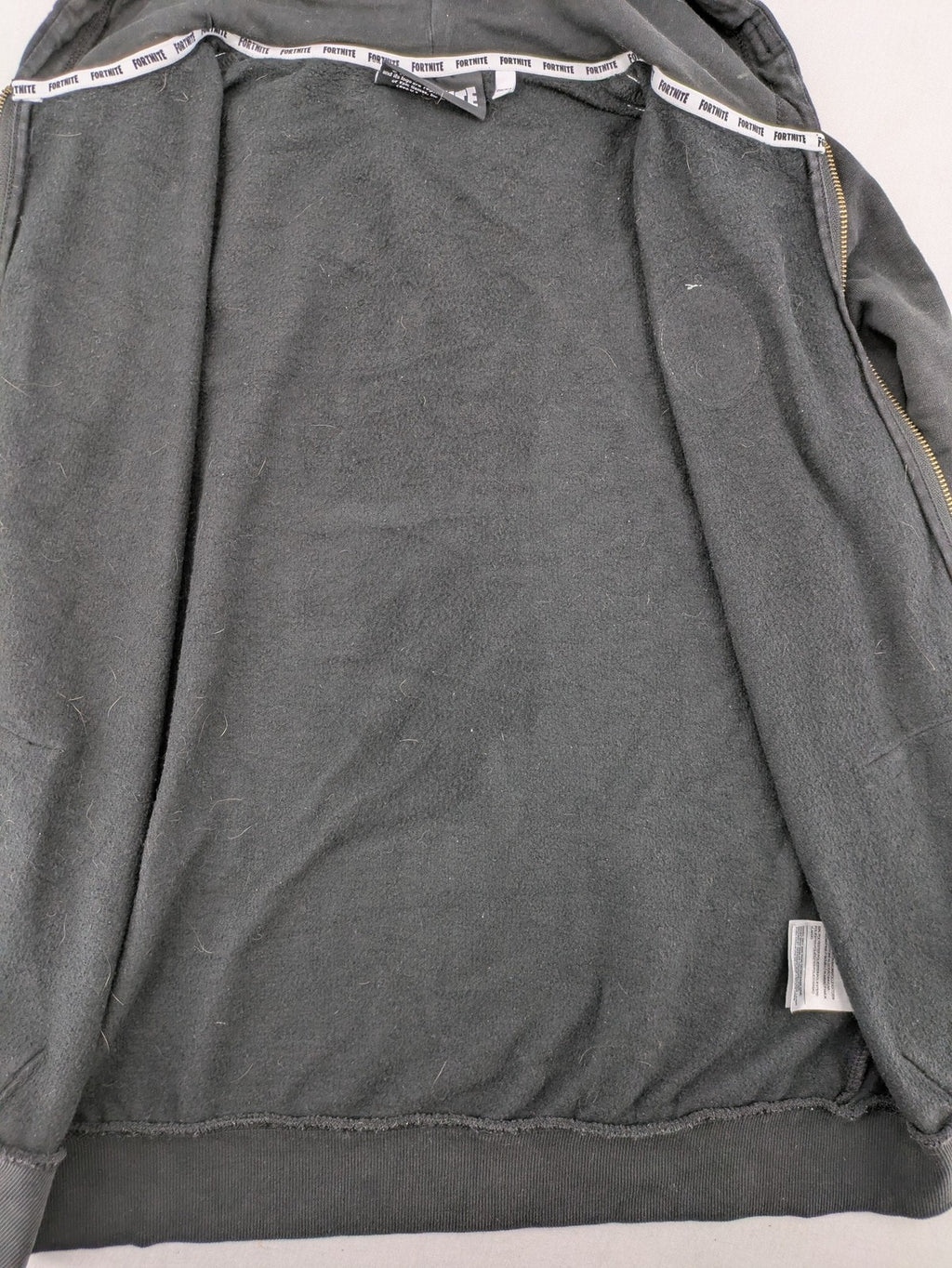 Fortnite black zip-through hoodie with logo on sleeves and Black Knight patch on chest.