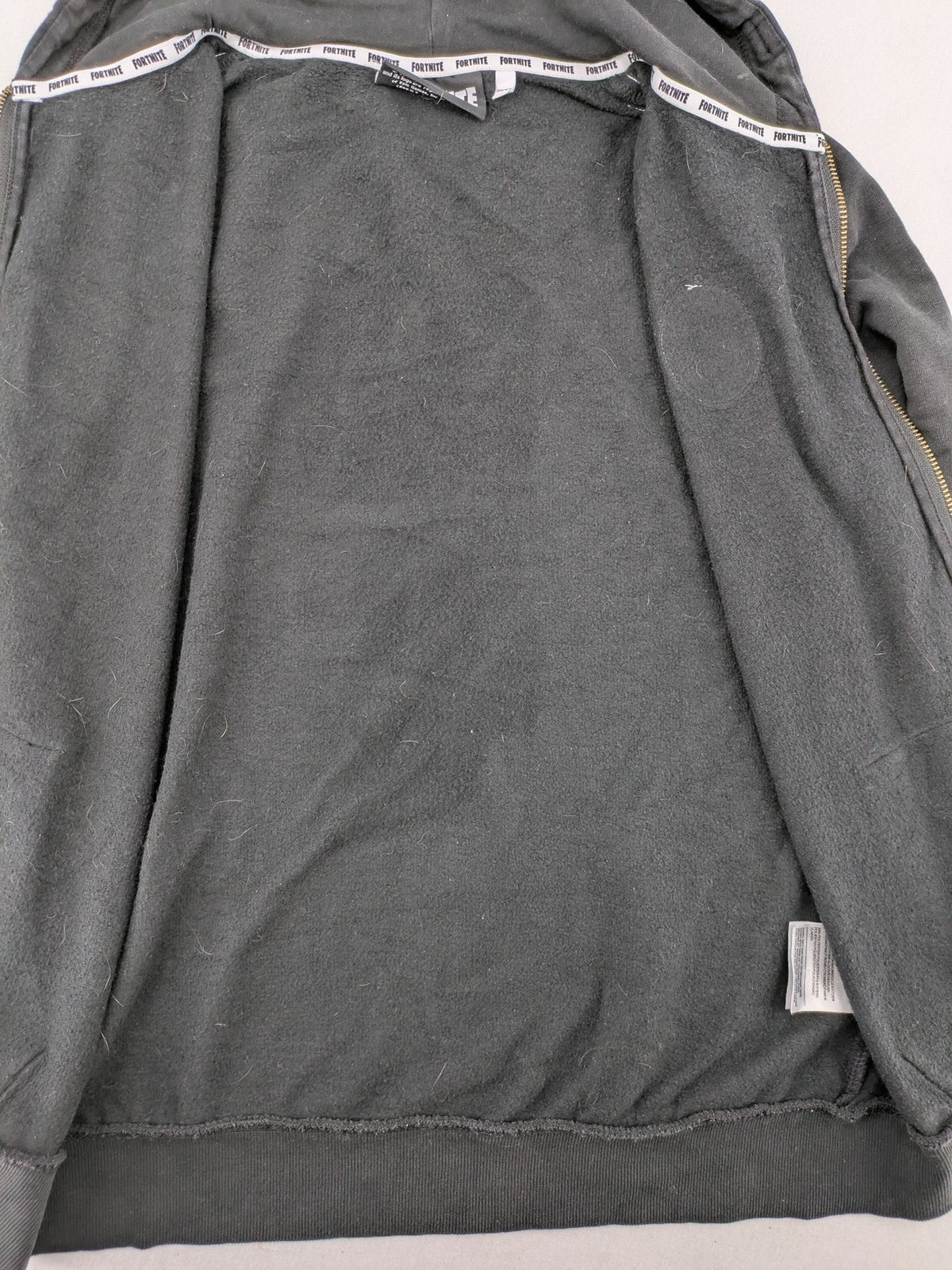Fortnite black zip-through hoodie with logo on sleeves and Black Knight patch on chest.