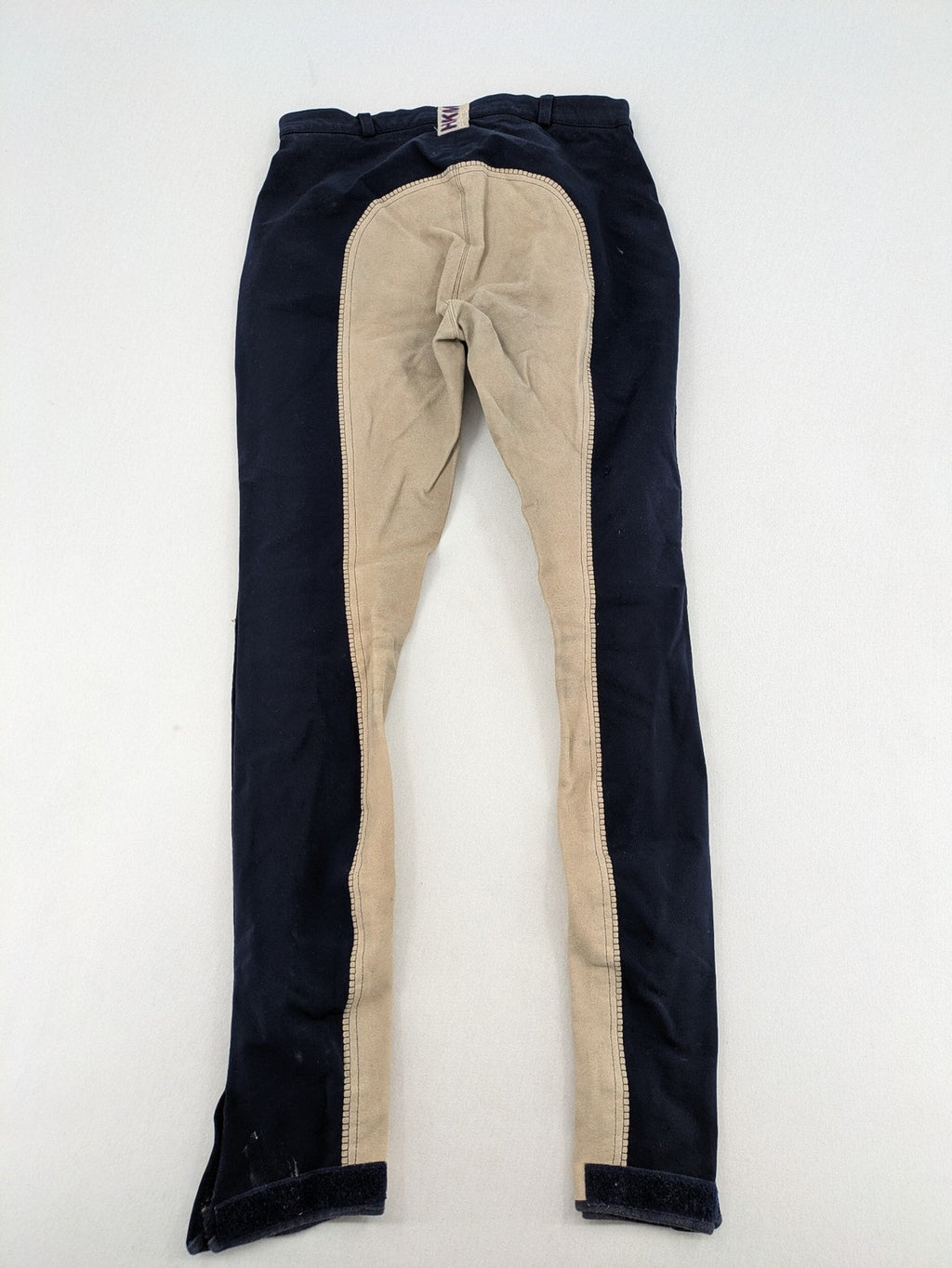 H&KM beige riding pants with dark blue full seat and front zippers.