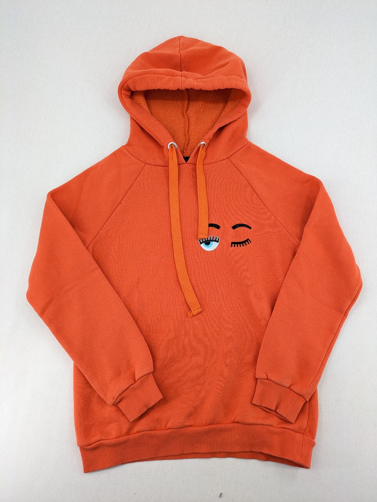 Ginatricot orange hoodie with embroidered winking eye detail, soft material, classic fit.