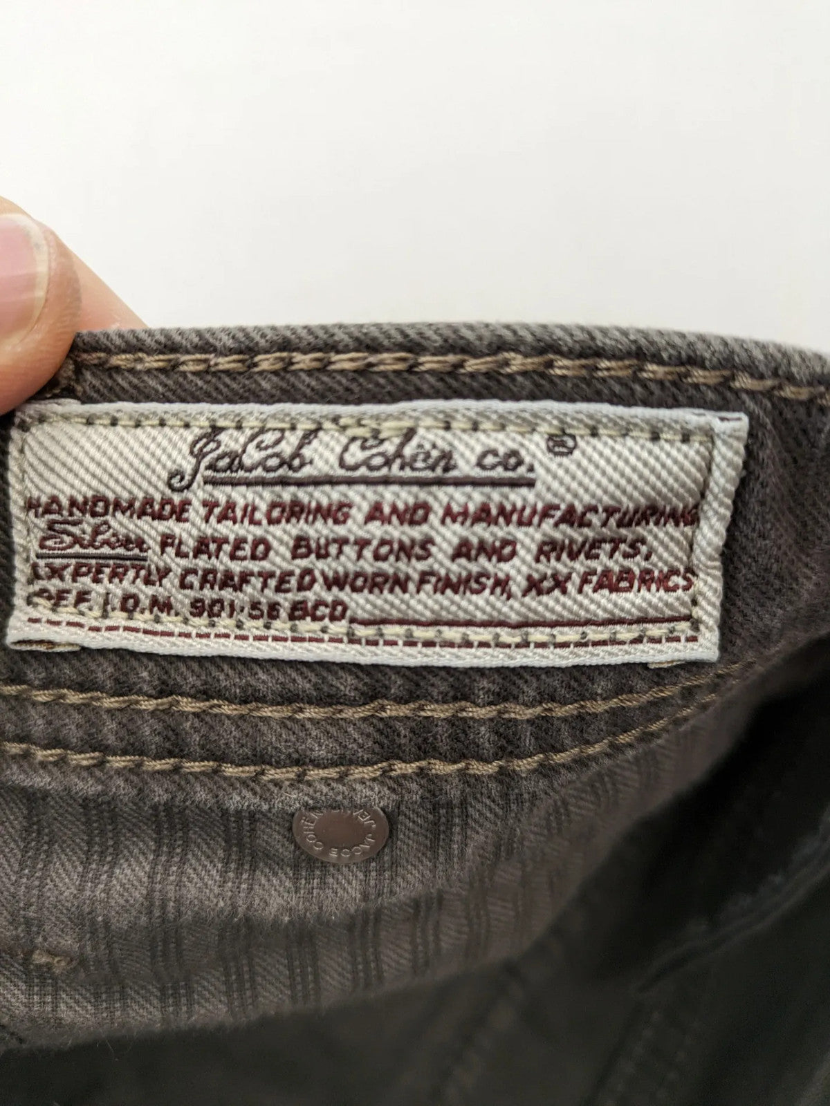 Jacob Cohen black straight jeans with leather logo patch and zip fly, size 32.
