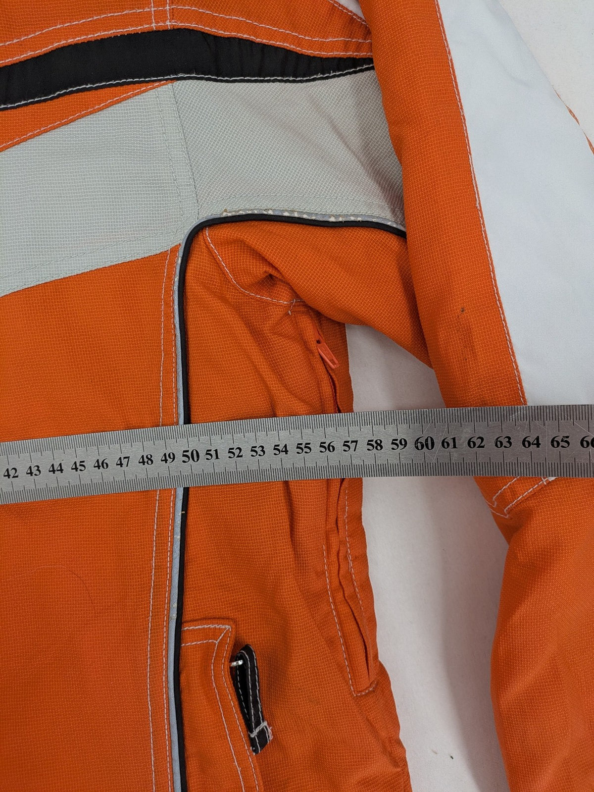 Outback orange outdoor jacket size 42 with reflective accents and mixed color details.