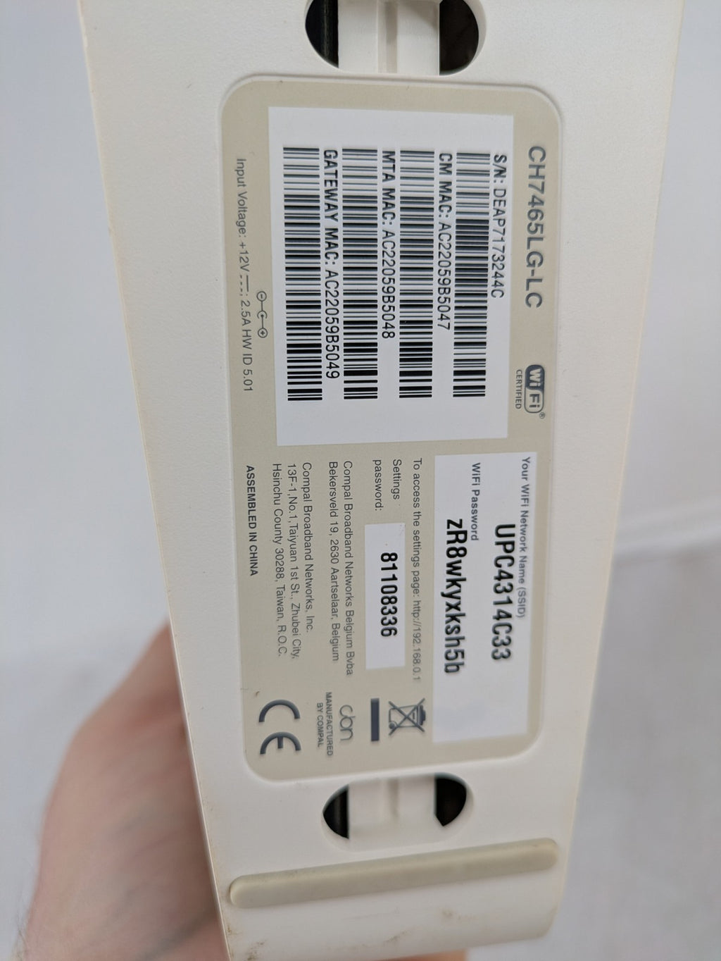 Compal beige WLAN modem router with integrated Wi-Fi and multiple LAN ports.