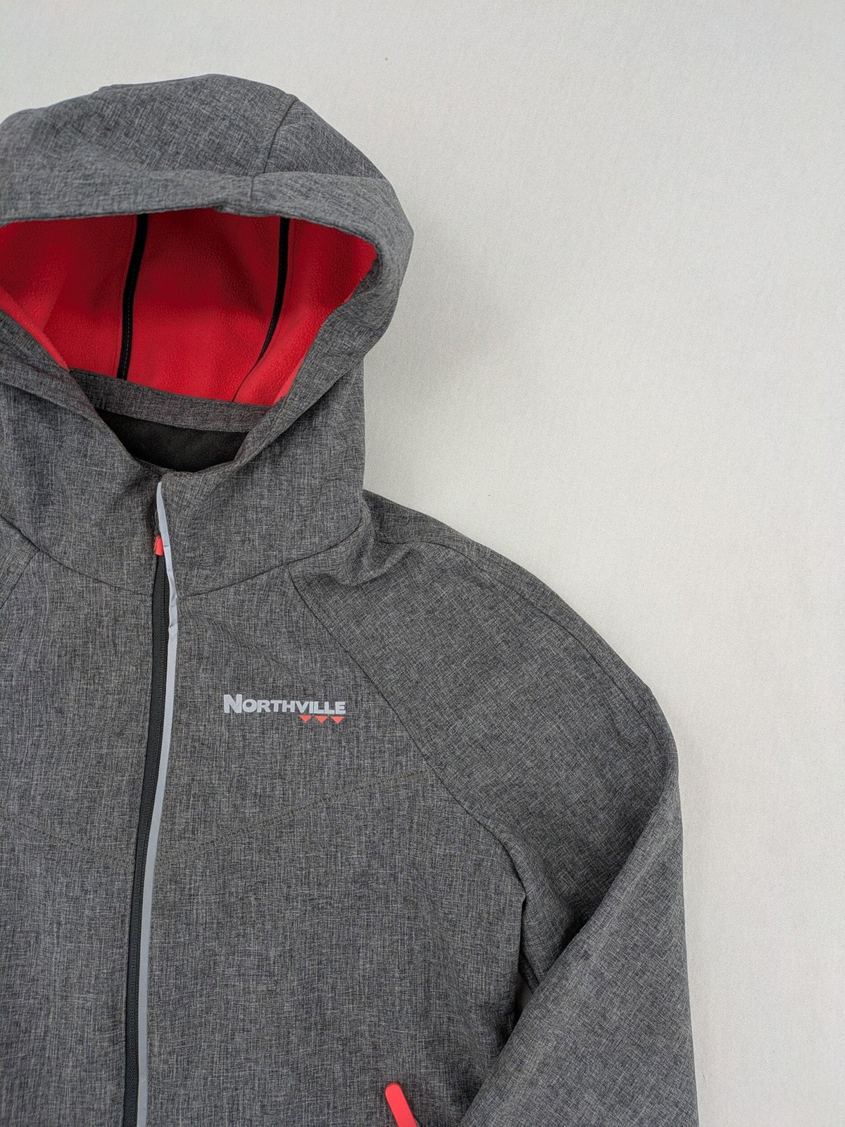 Northville grey and red softshell jacket with hood, fleece lining, and reflective elements.