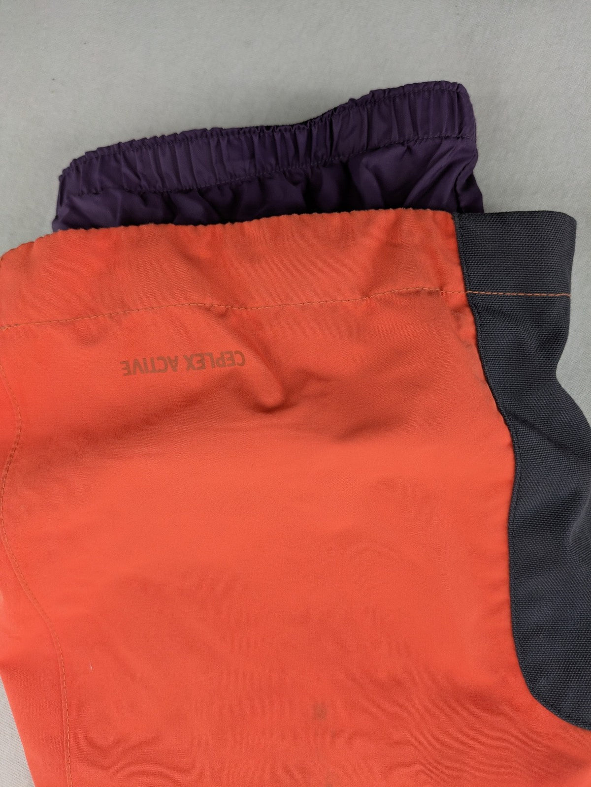 Vaude orange ski pants with logo, Primaloft insulation, and Ceplex Active membrane.