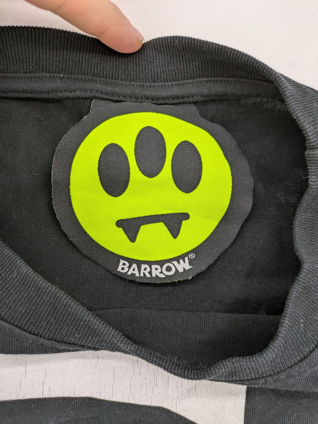 Barrow grey t-shirt with large black and white smiley graphic print and logo patch.