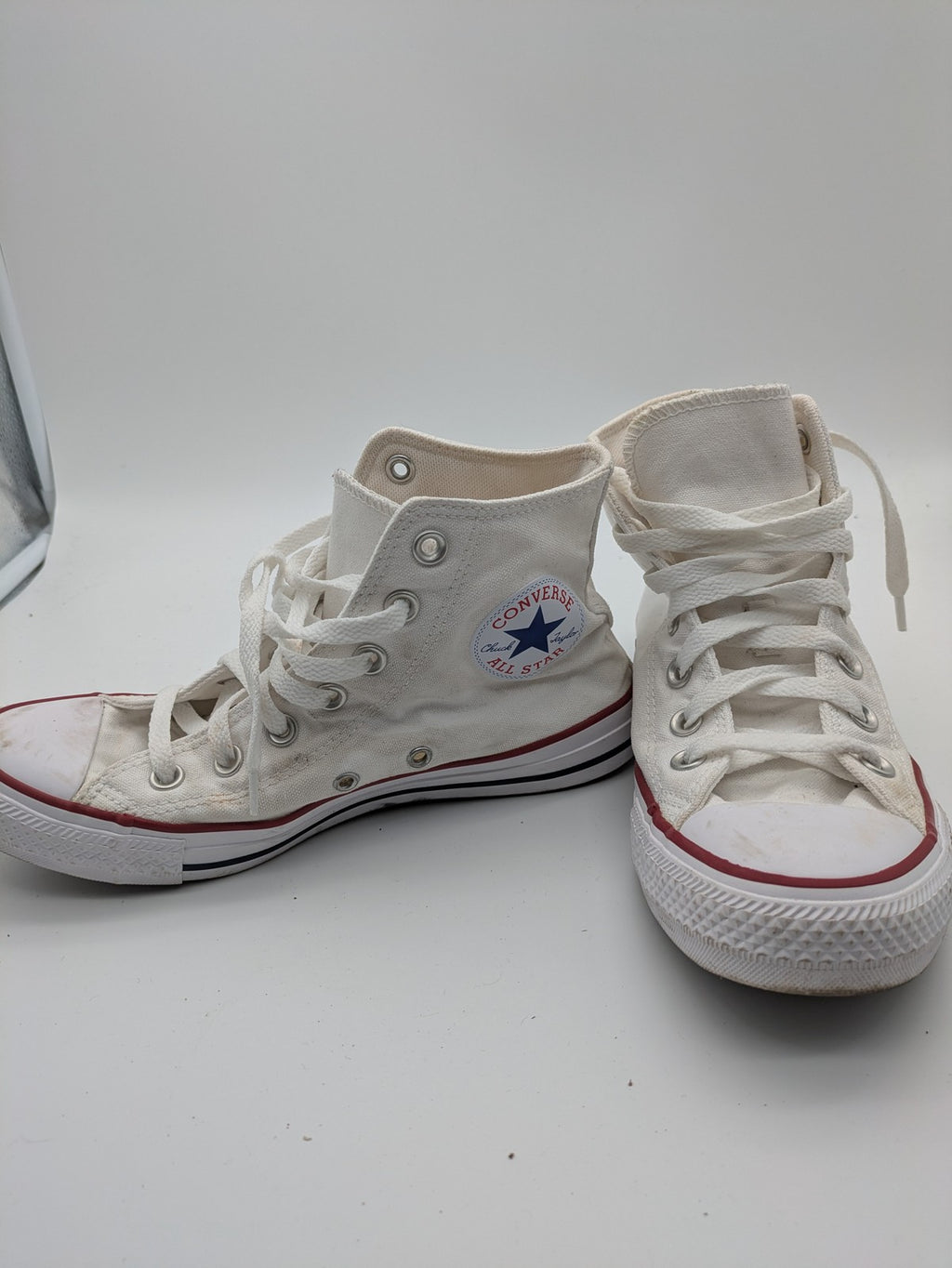 Converse Chuck Taylor All Star high top sneakers black canvas with red and white accents.