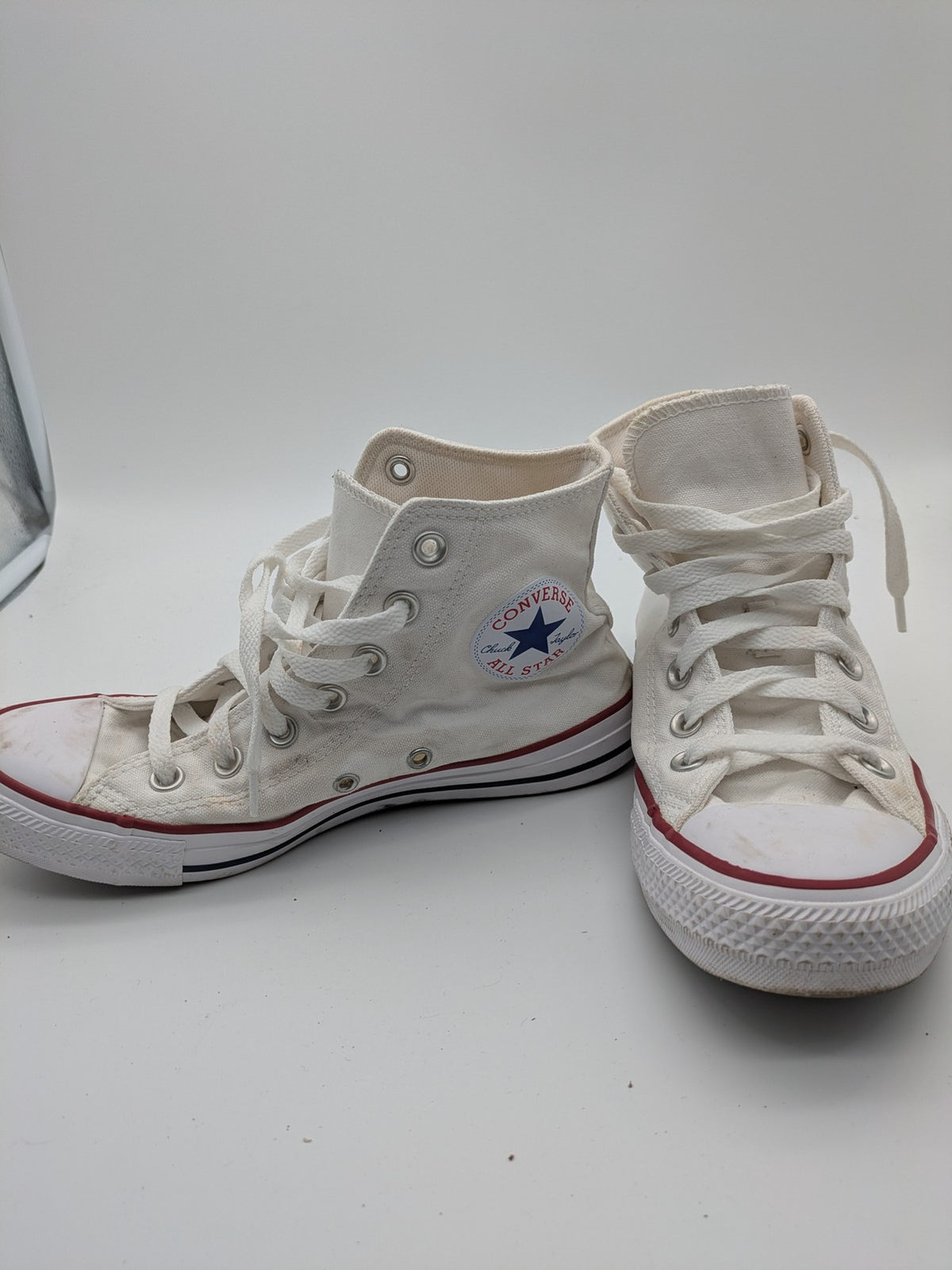 Converse Chuck Taylor All Star high top sneakers black canvas with red and white accents.