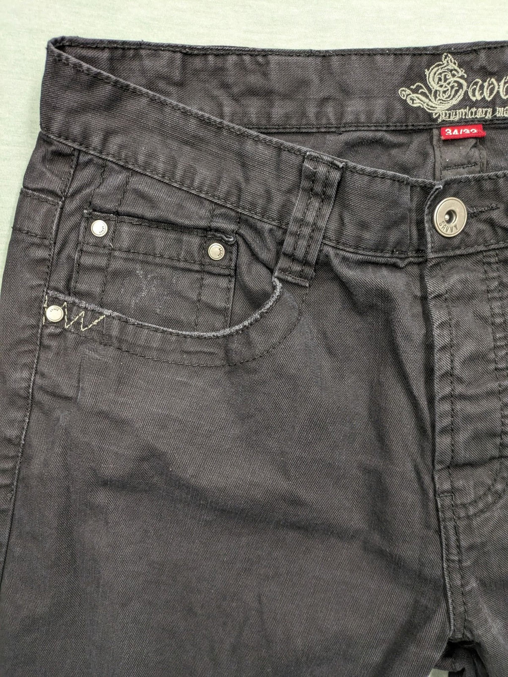 Savvy black pants straight fit with button fly, embroidered details and unique stitching.