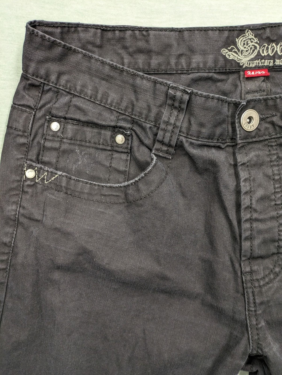 Savvy black pants straight fit with button fly, embroidered details and unique stitching.