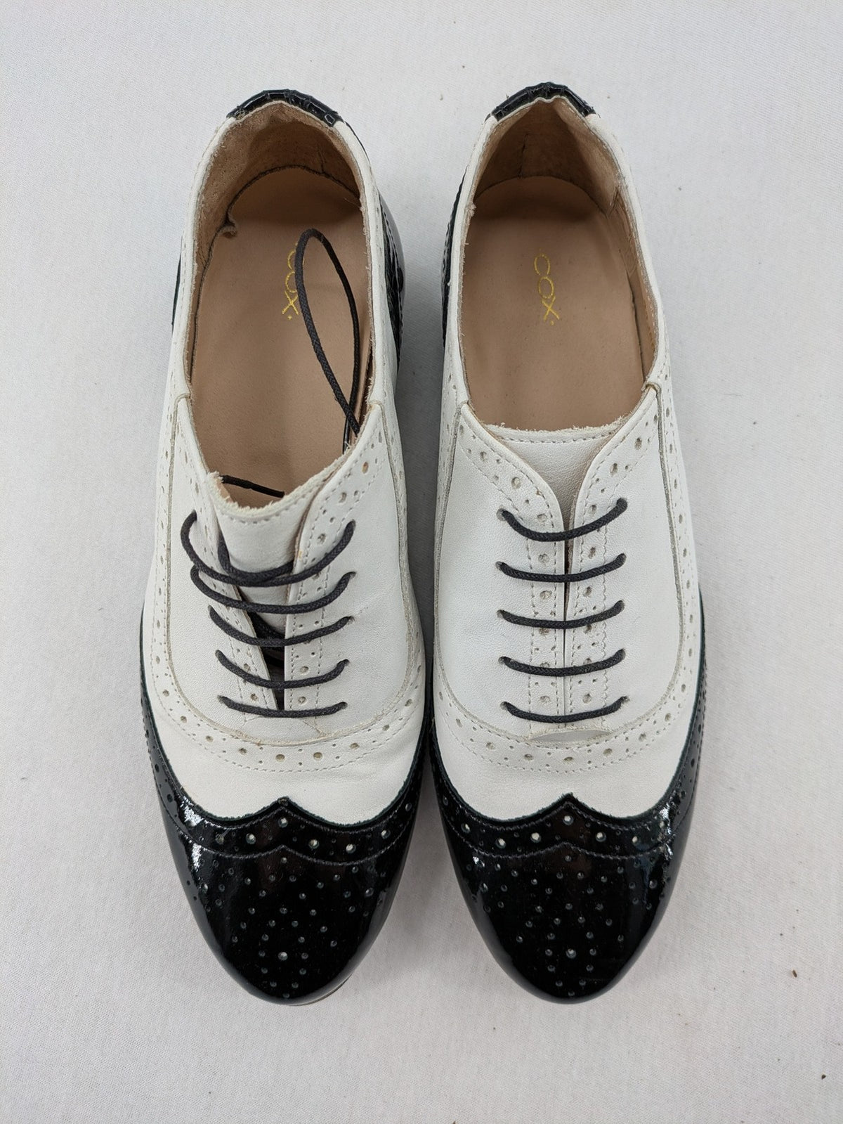 Kontrast black and white deck shoes, glossy patent leather with wingtip cap and brogue detailing.