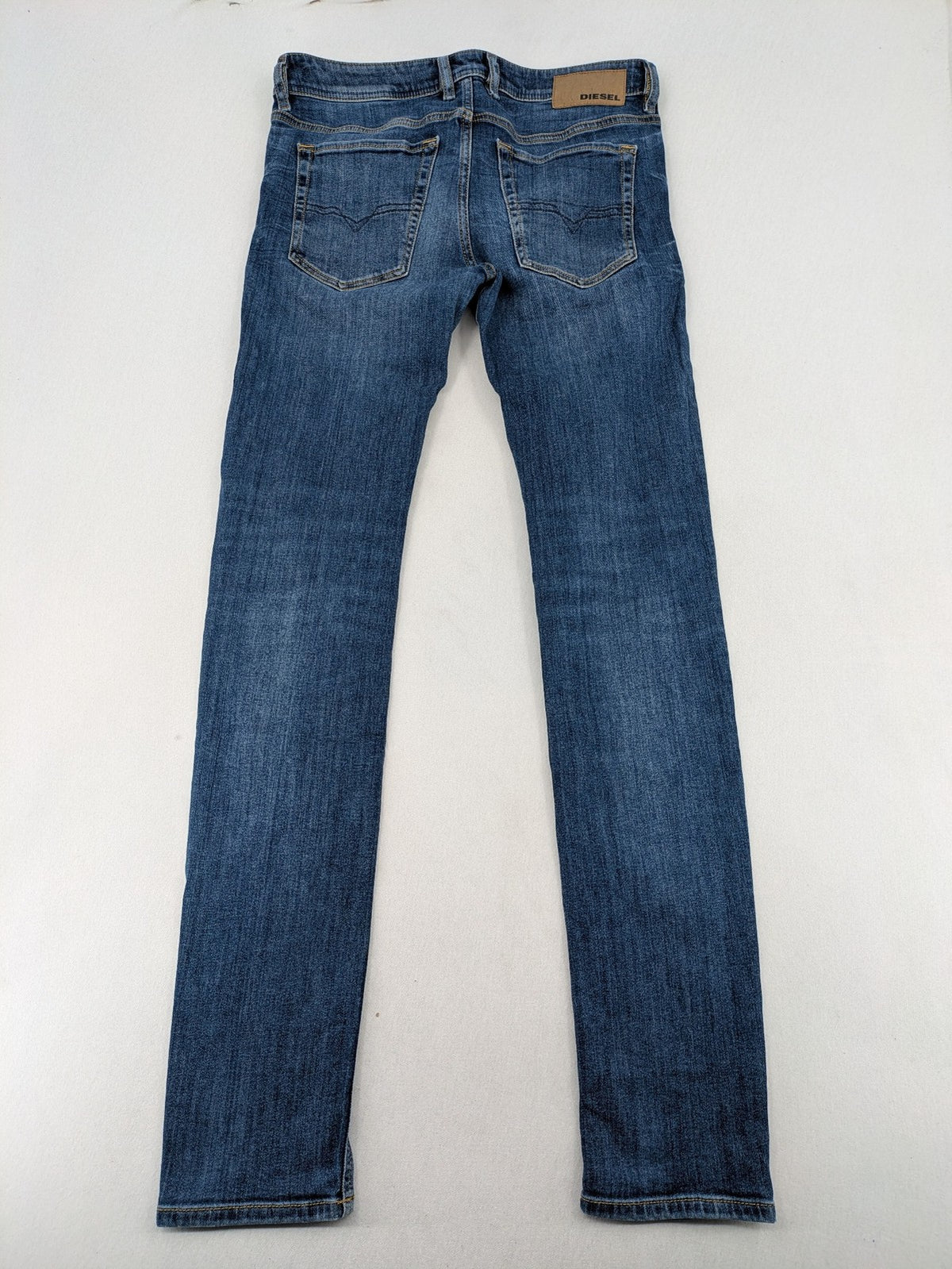 Diesel blue slim skinny jeans with logo patch and stretch denim material.