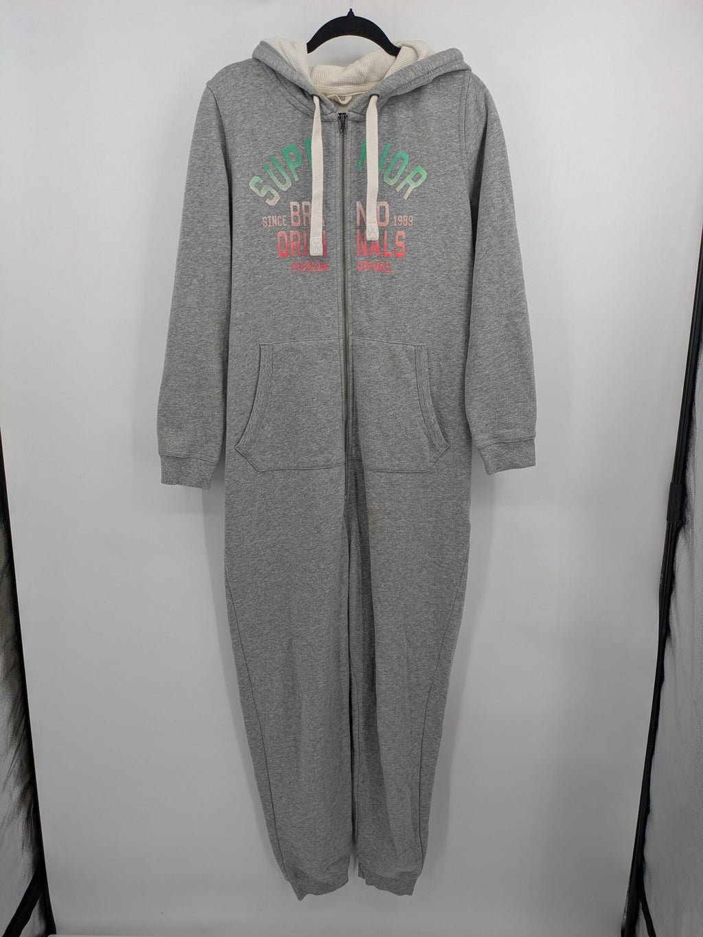 ESMARA cream jumpsuit with hood, graphic print, and front zipper, soft material.
